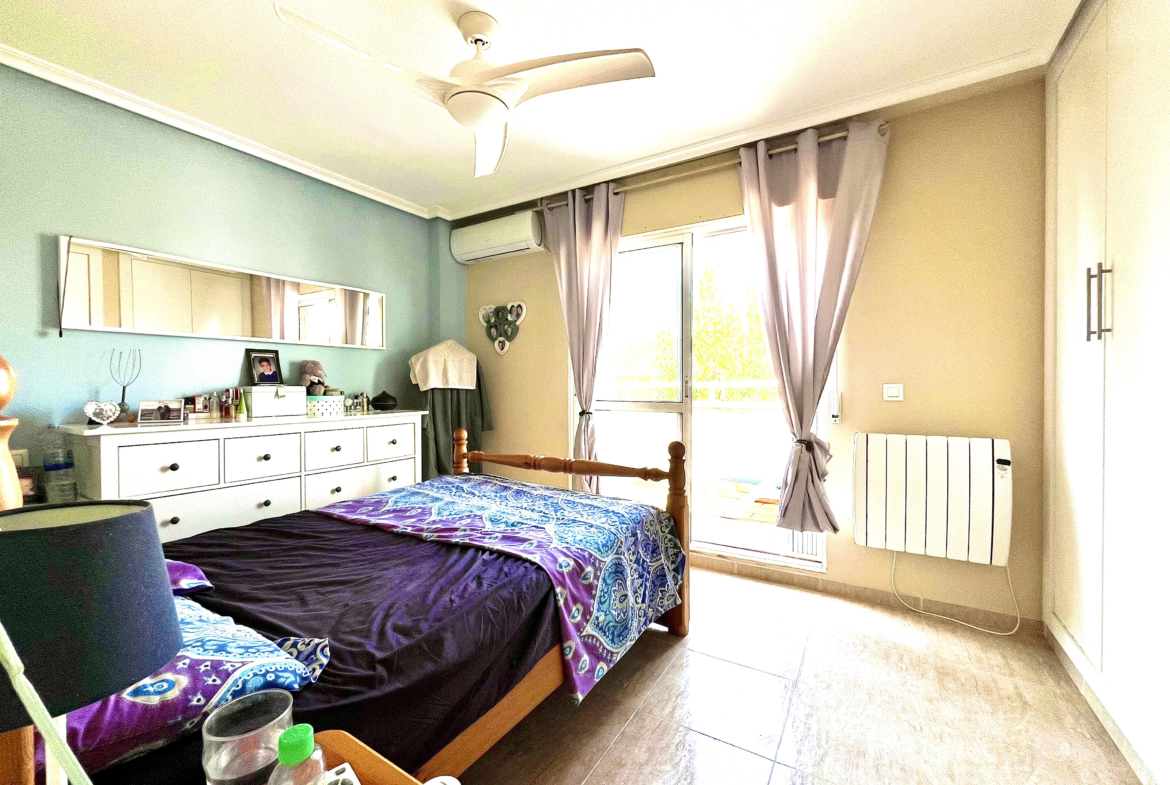 Master bedroom with built-in wardrobes and private terrace in Los Narejos home by Levante Properties.