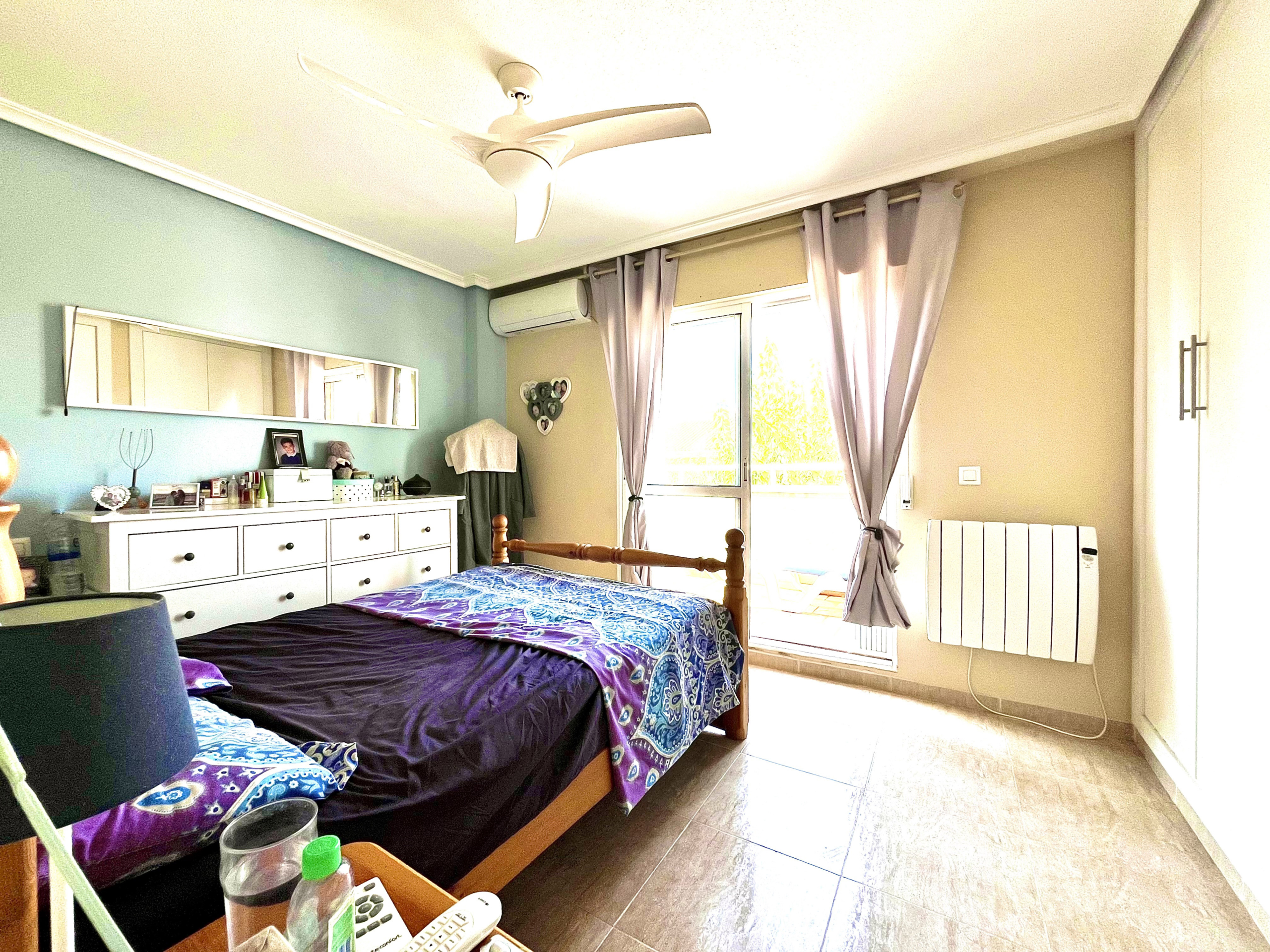 Master bedroom with built-in wardrobes and private terrace in Los Narejos home by Levante Properties.