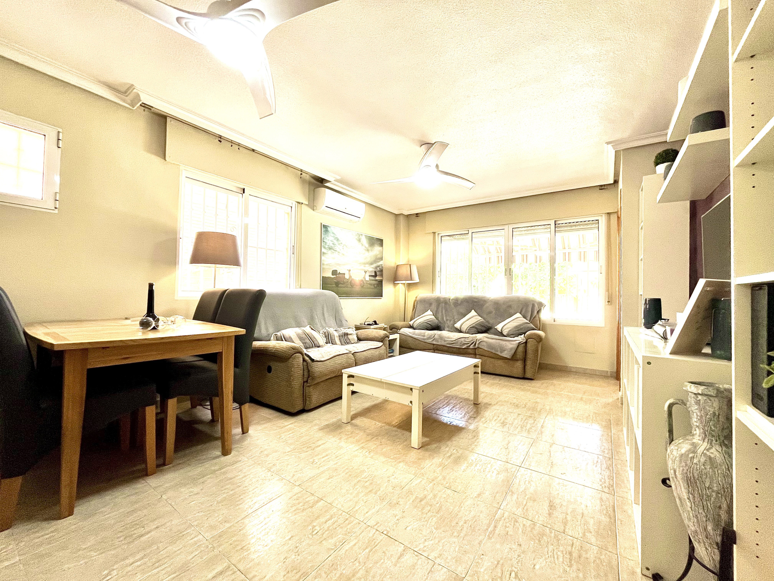 Spacious living and dining room with air conditioning in Los Narejos house marketed by Levante Properties.