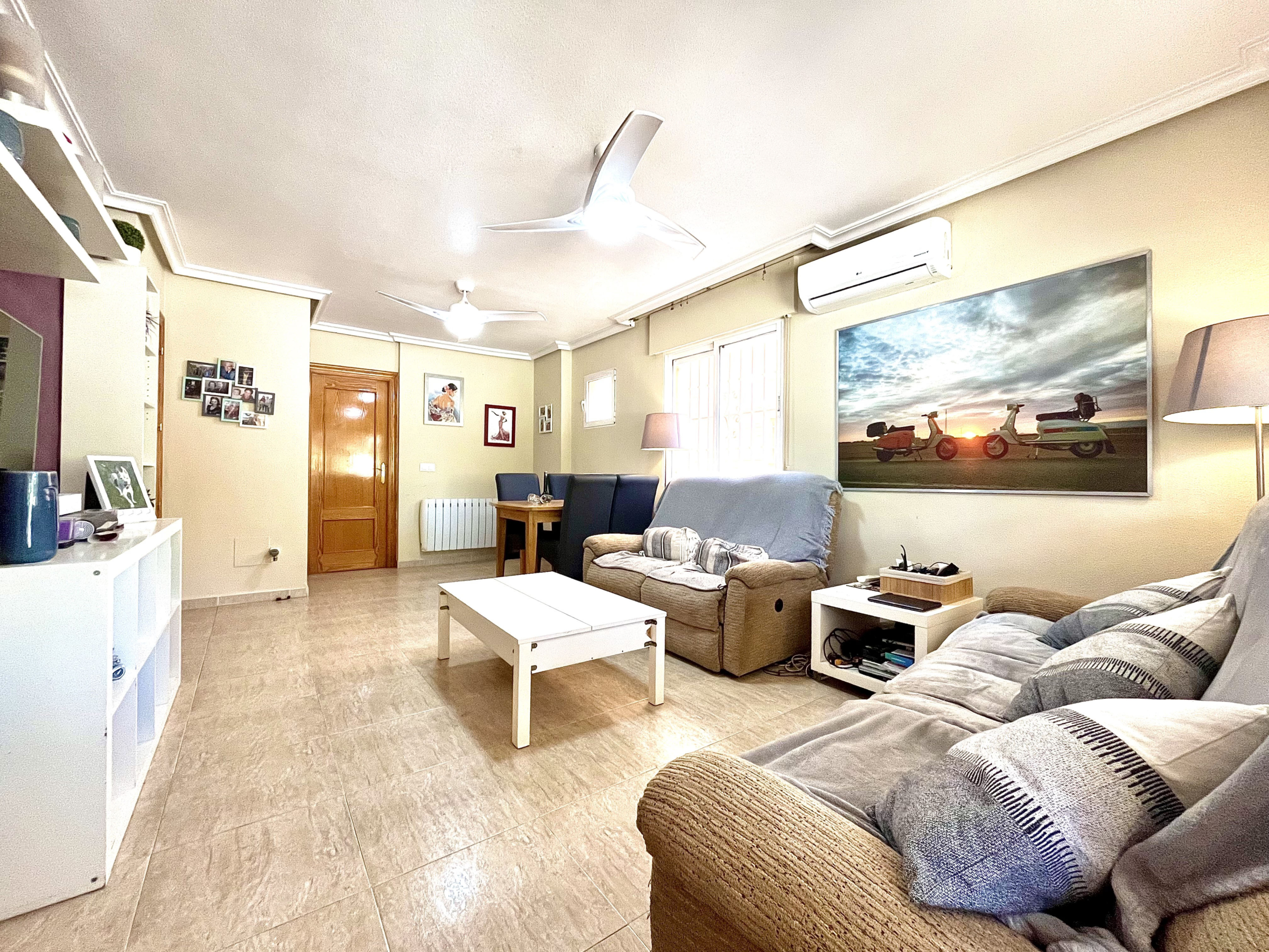 Spacious living and dining room with air conditioning in Los Narejos house marketed by Levante Properties.