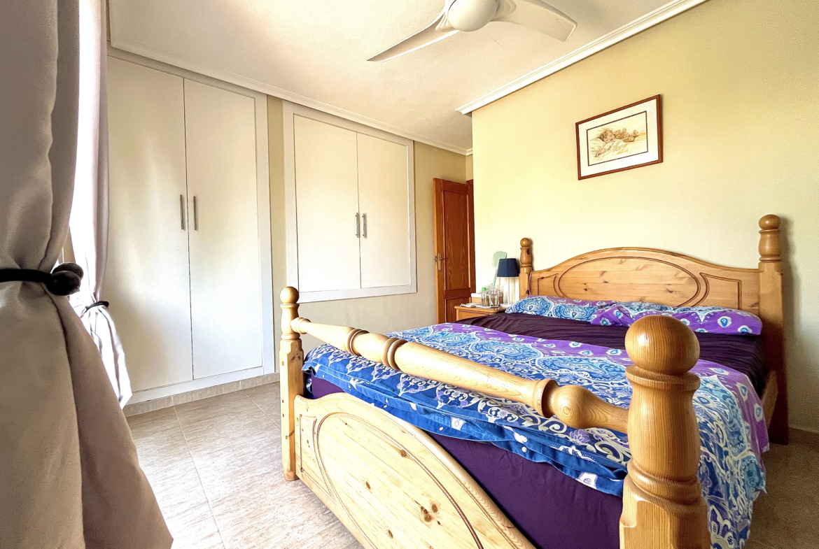 Master bedroom with built-in wardrobes and private terrace in Los Narejos home by Levante Properties.