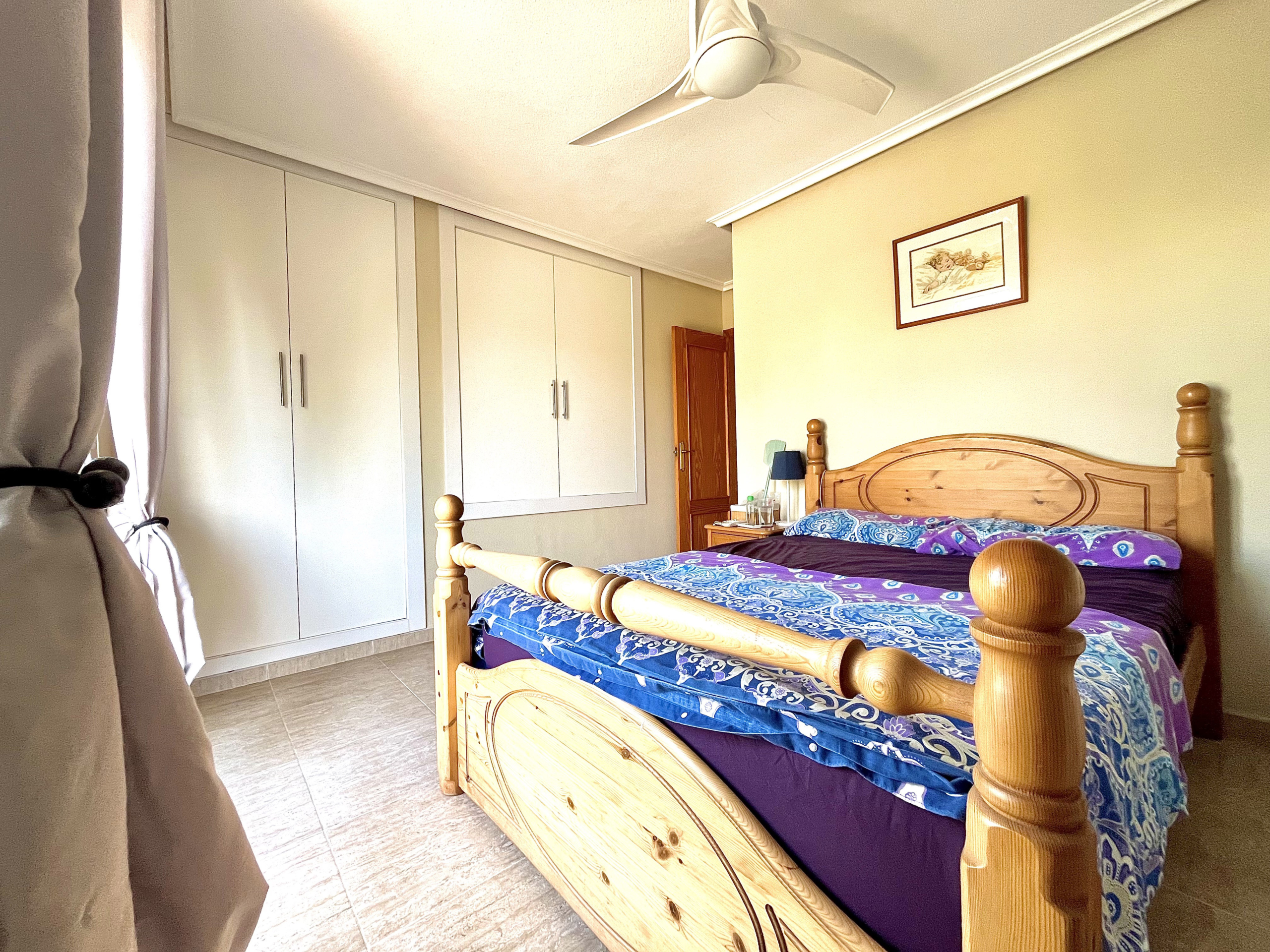 Master bedroom with built-in wardrobes and private terrace in Los Narejos home by Levante Properties.