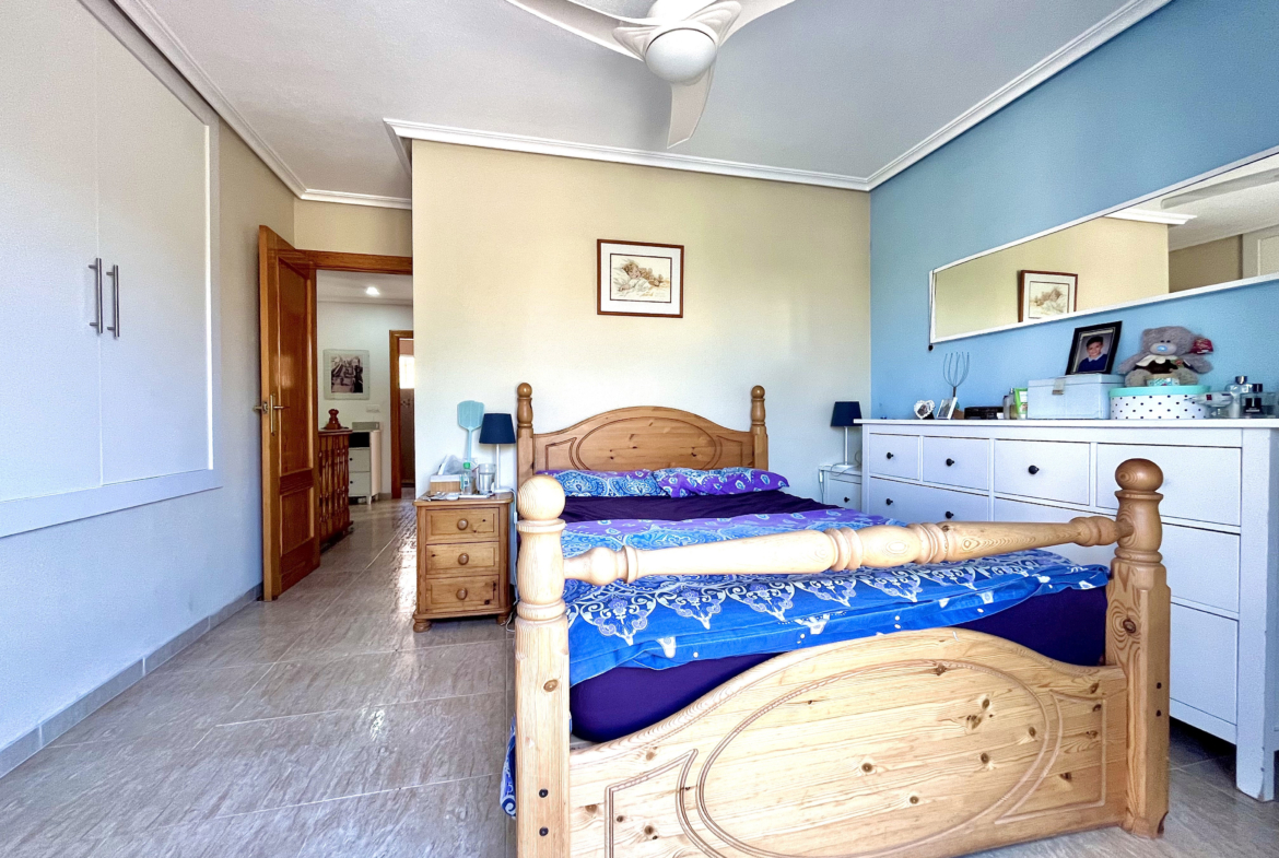 Master bedroom with built-in wardrobes and private terrace in Los Narejos home by Levante Properties.