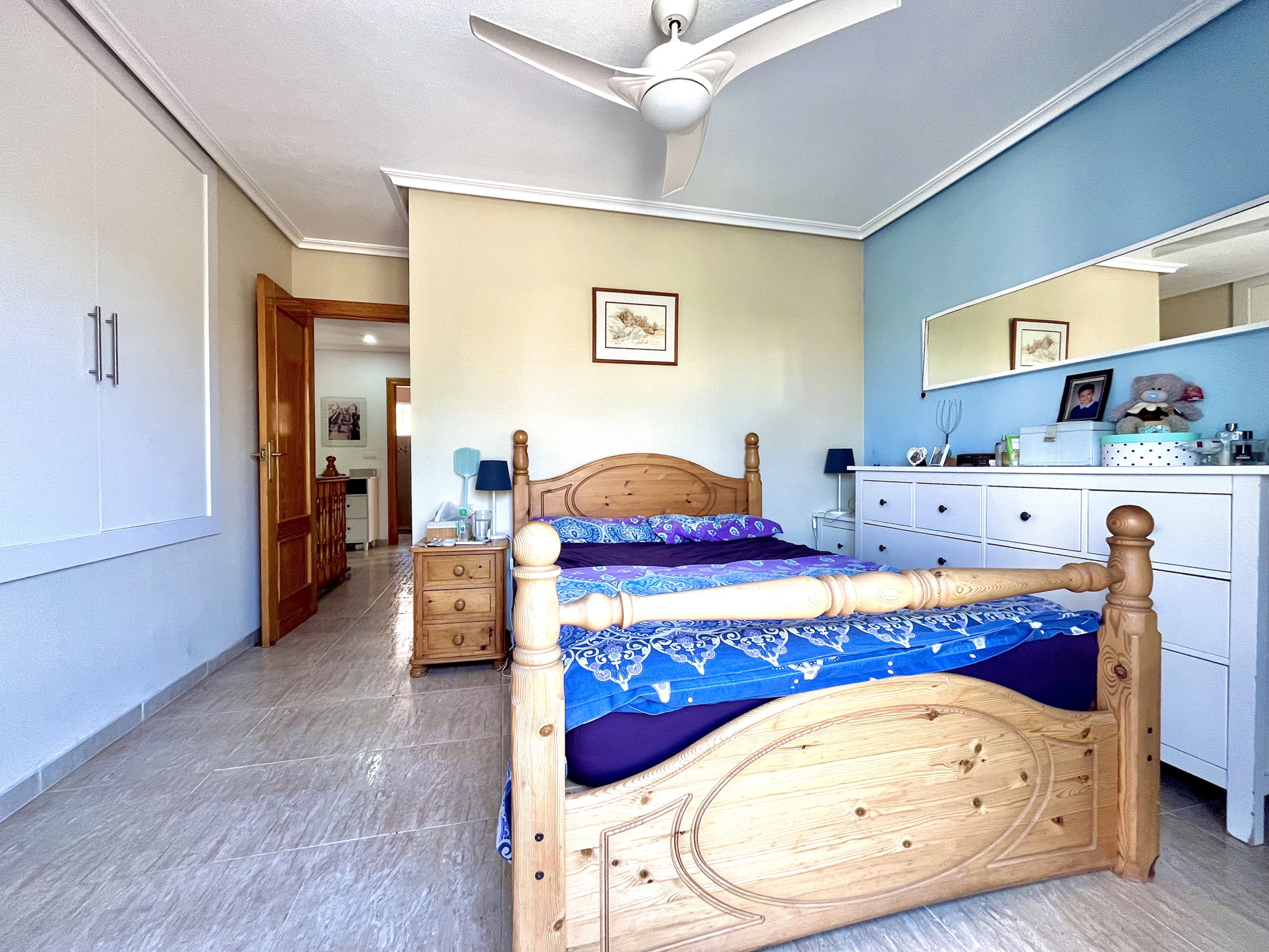 Master bedroom with built-in wardrobes and private terrace in Los Narejos home by Levante Properties.