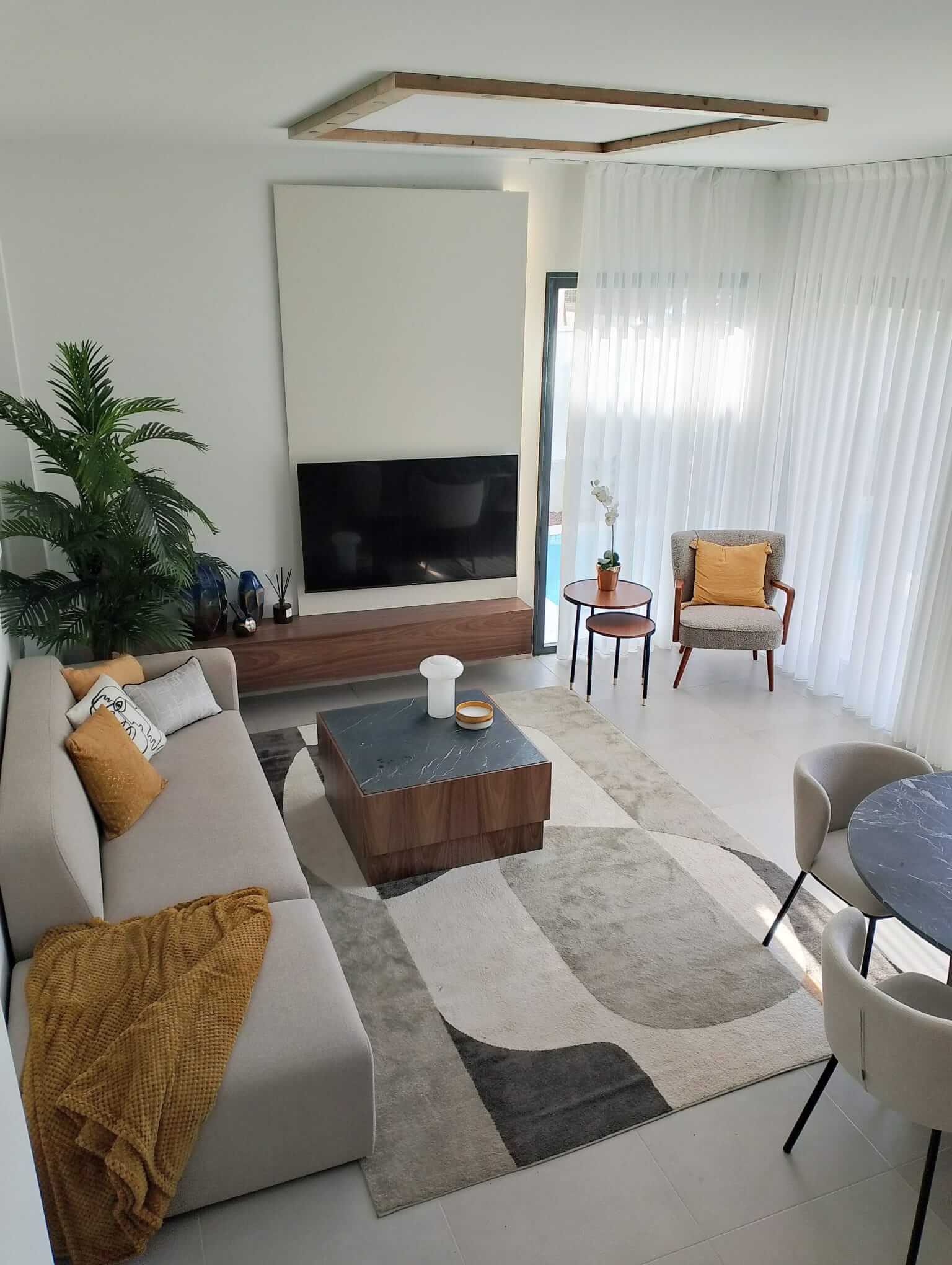 Modern open-plan living and dining area in Tindra Villas at Roda Golf by Levante Properties
