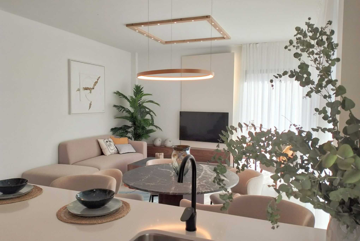 Modern open-plan living and dining area in Tindra Villas at Roda Golf by Levante Properties