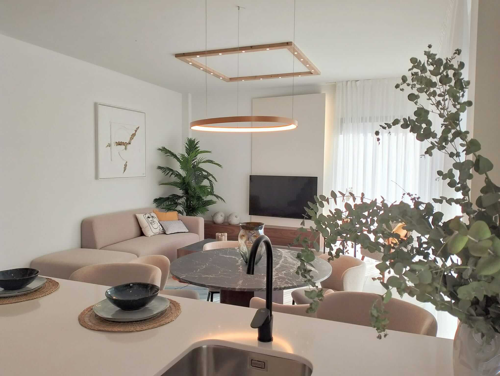 Modern open-plan living and dining area in Tindra Villas at Roda Golf by Levante Properties