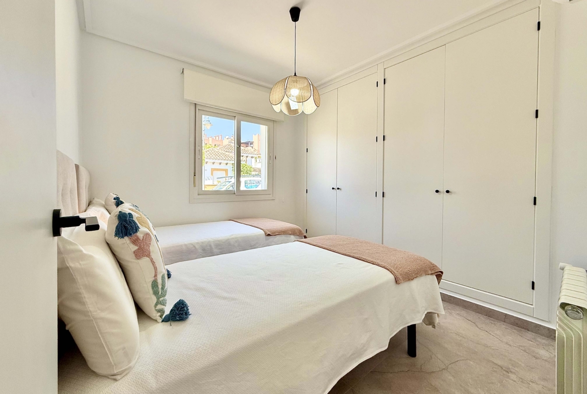 Modernised bedroom with climate control at the Rondella villa in Mar Menor Golf Resort.