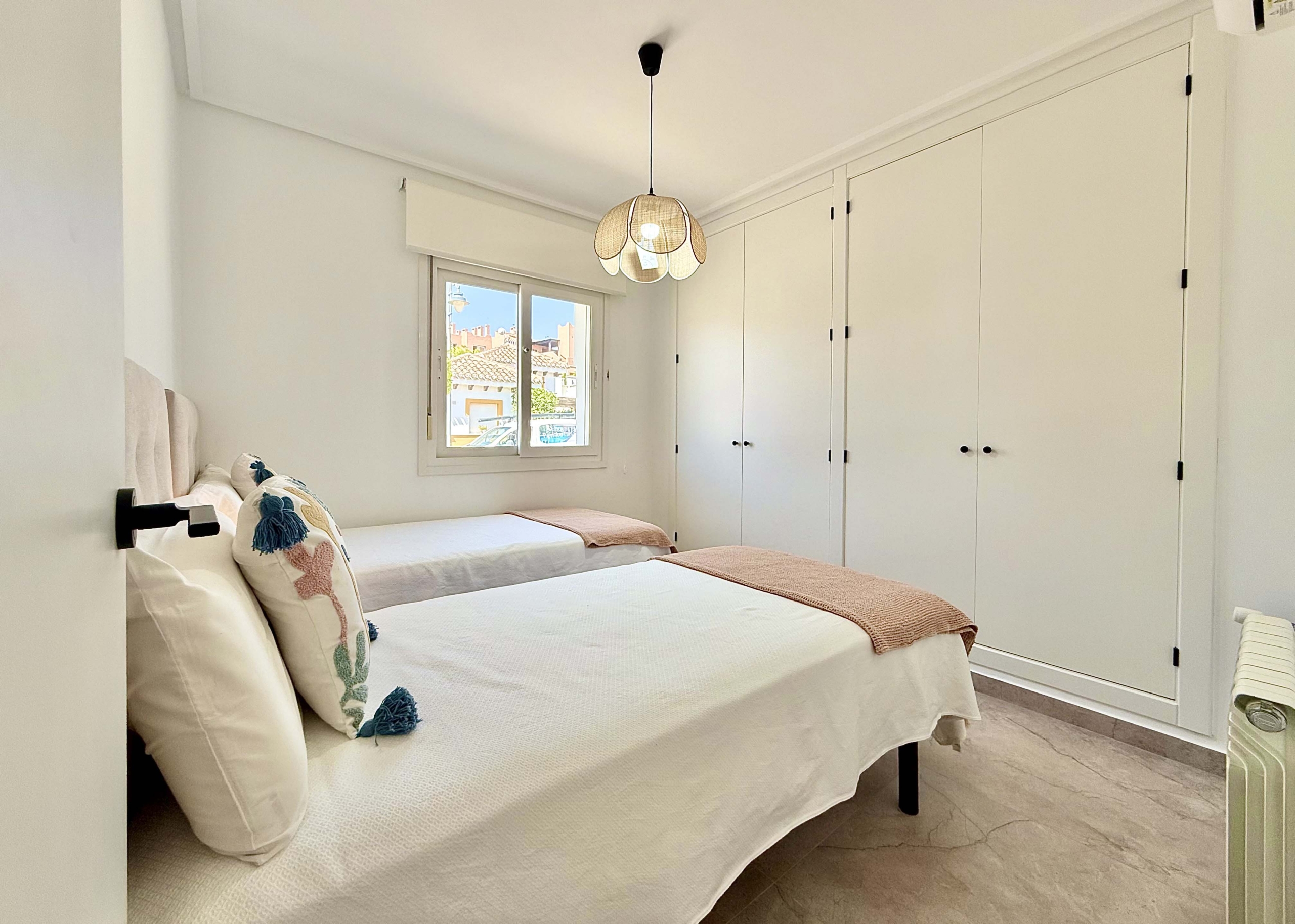 Modernised bedroom with climate control at the Rondella villa in Mar Menor Golf Resort.