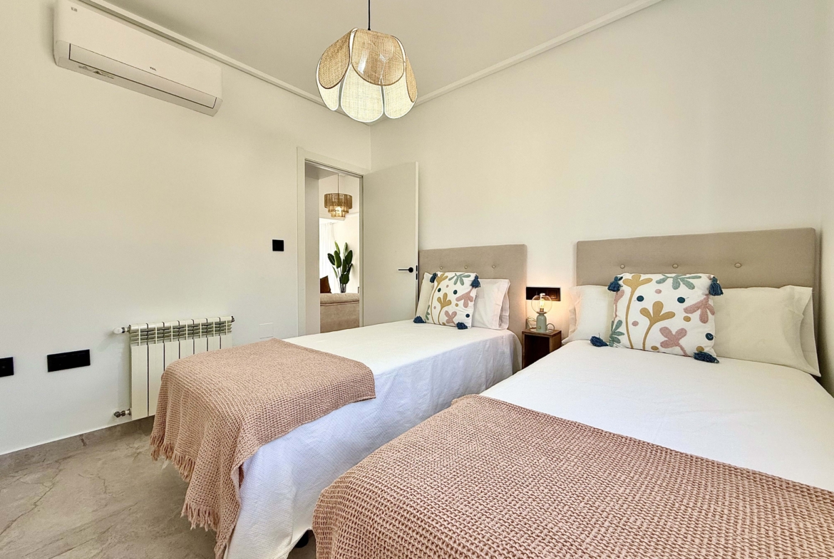 Modernised bedroom with climate control at the Rondella villa in Mar Menor Golf Resort.