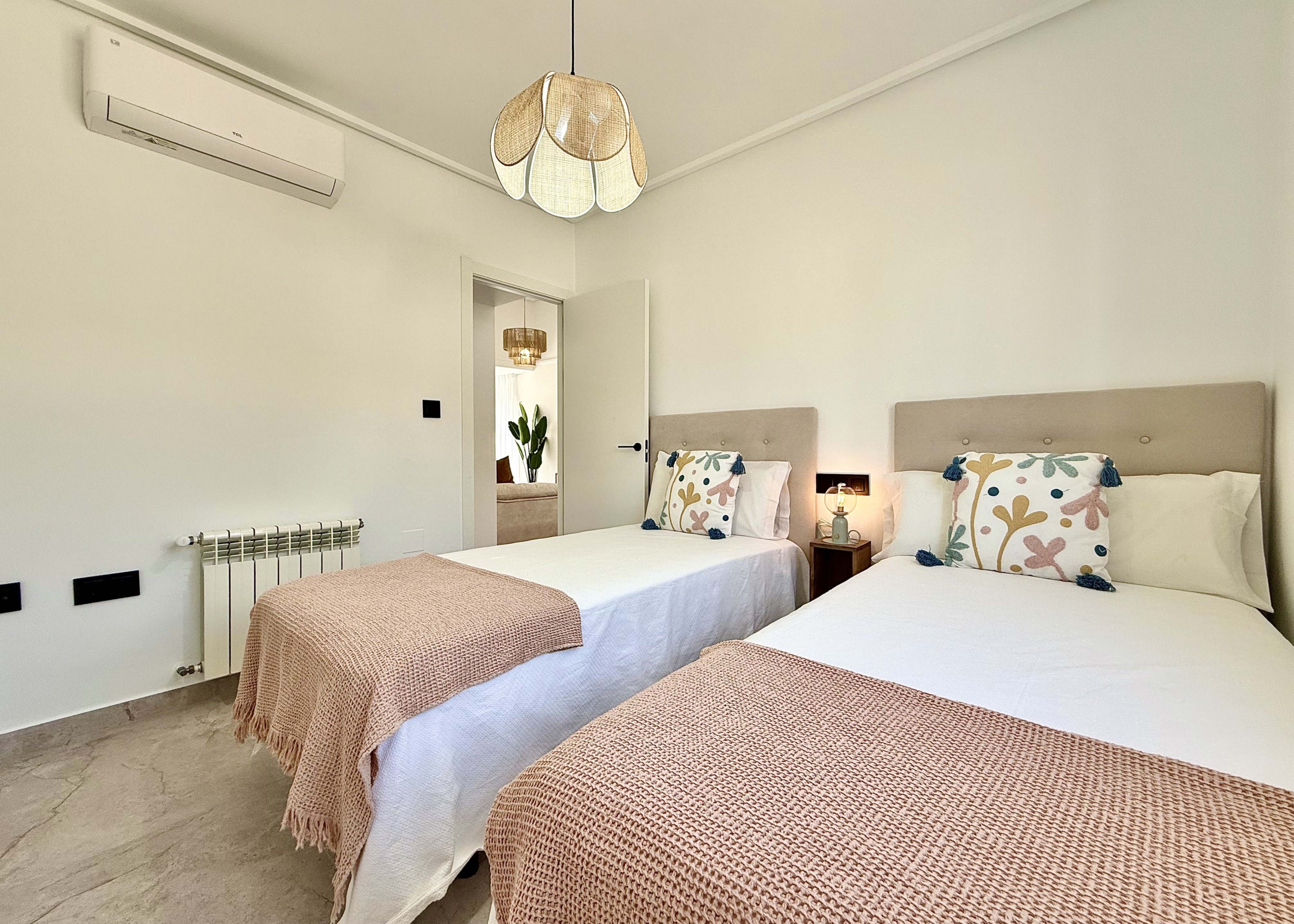 Modernised bedroom with climate control at the Rondella villa in Mar Menor Golf Resort.