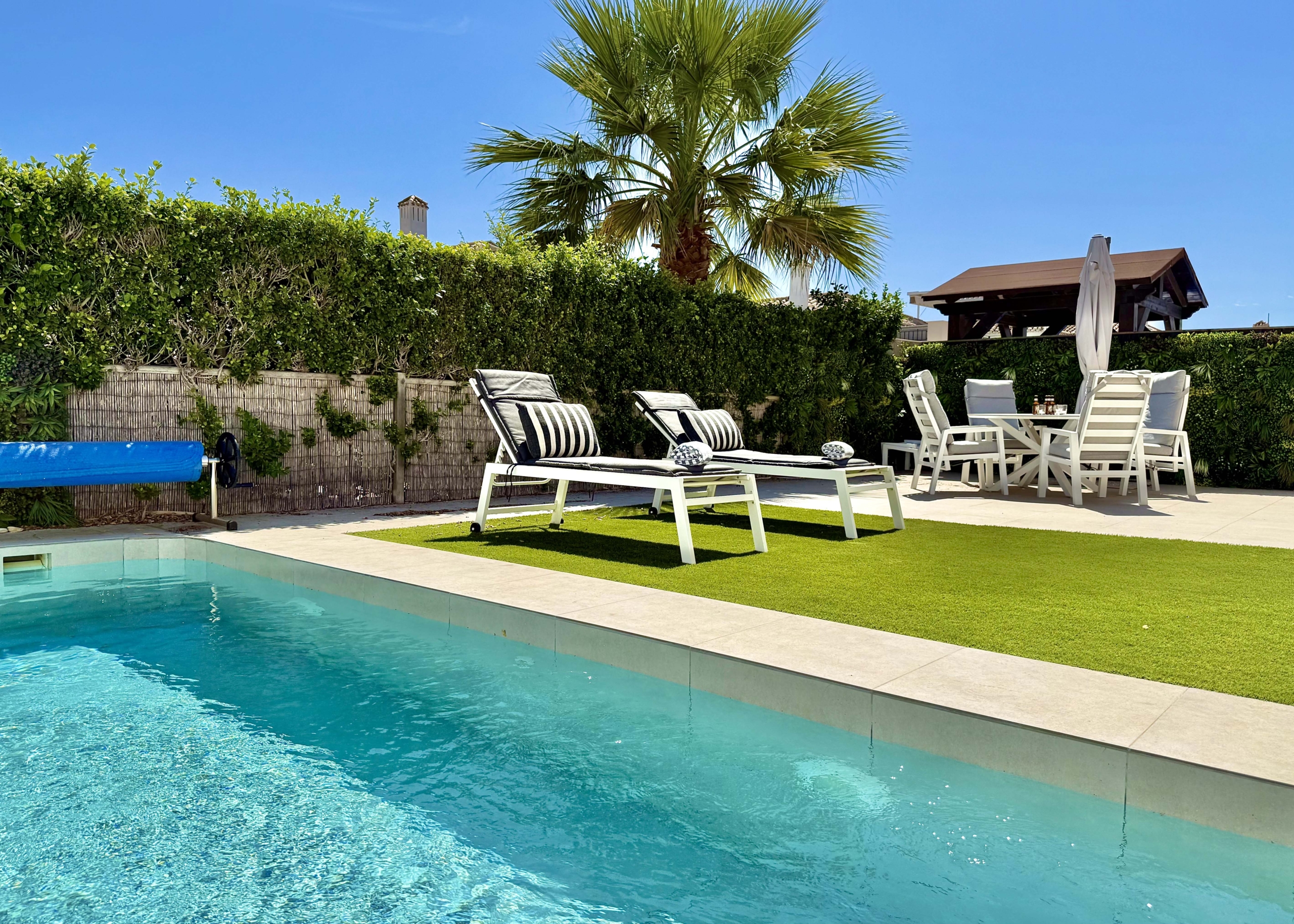 Private heated pool and landscaped garden at the Rondella villa in Mar Menor Golf Resort.