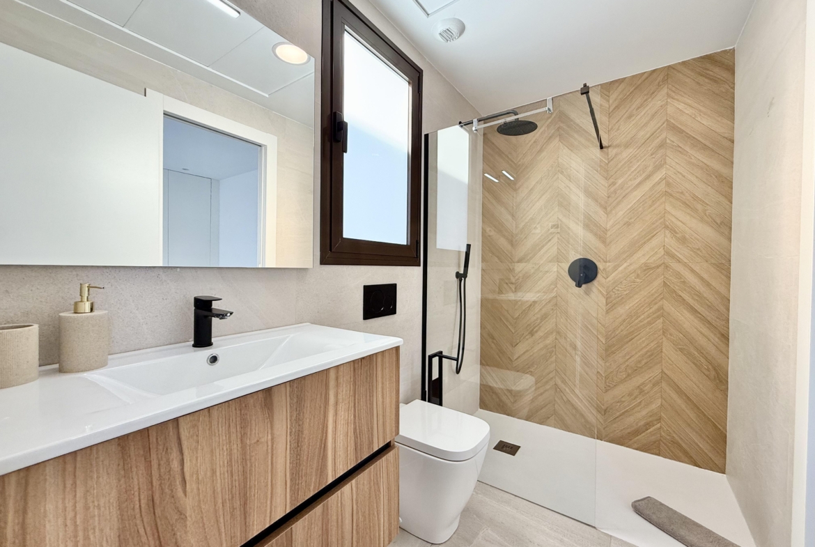 Stylish bathroom with walk-in shower presented by Levante Properties