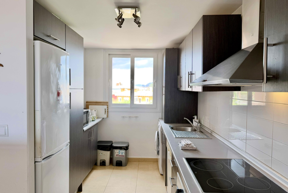 Modern open-plan kitchen in luxury penthouse Mar Menor Golf Resort Levante Properties