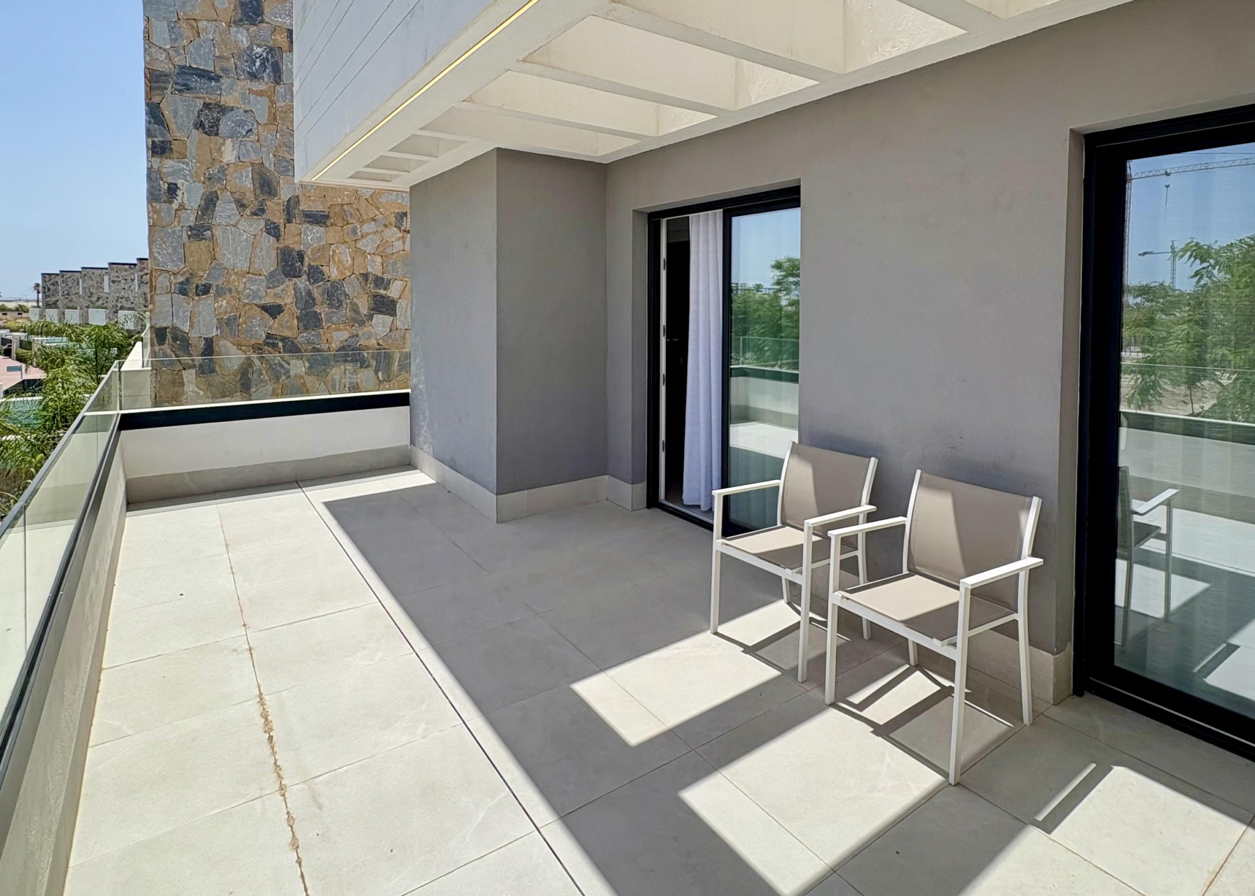 Master bedroom with balcony overlooking the pool and lake at Santa Rosalía
