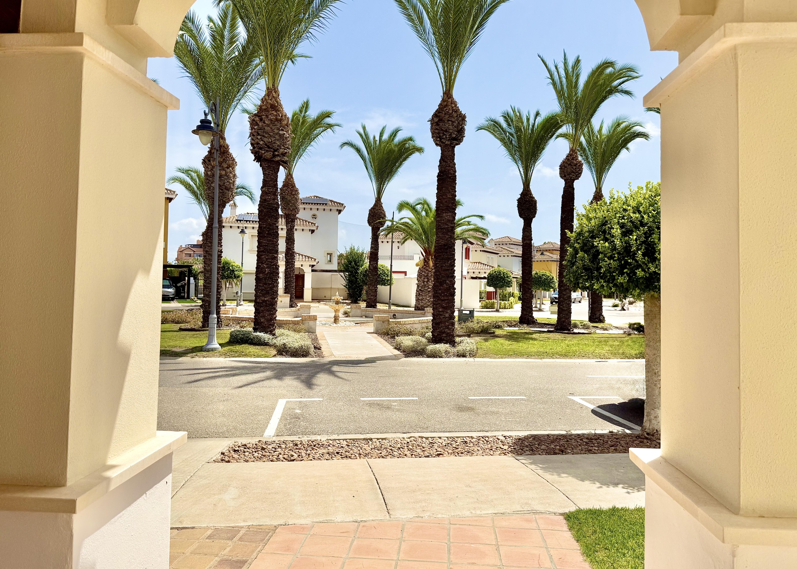 Front exterior of a Baron villa with fountain views at Mar Menor Golf Resort, presented by Levante Properties.
