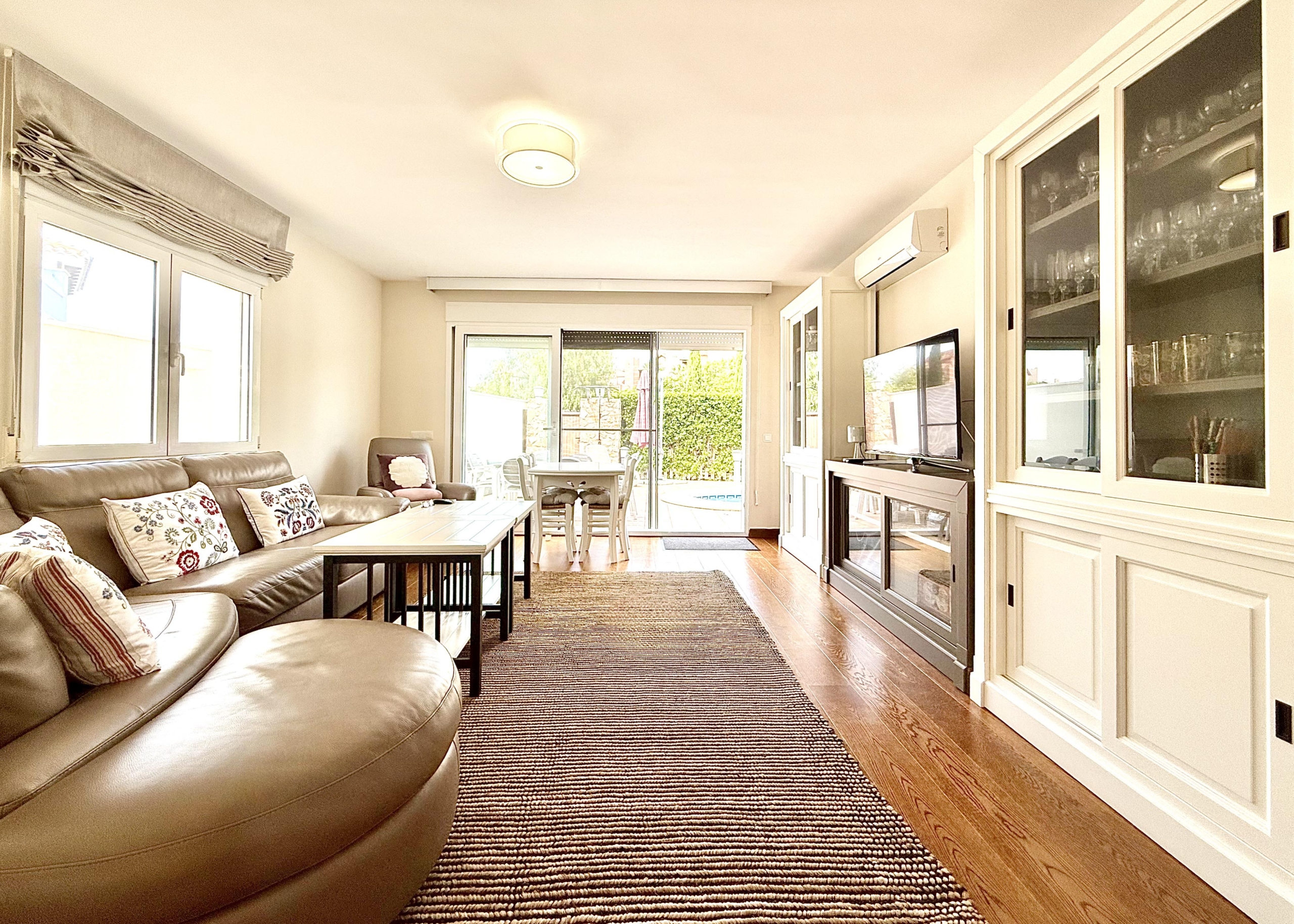Spacious living and dining area with laminate flooring in a Levante Properties villa at Mar Menor Golf Resort.