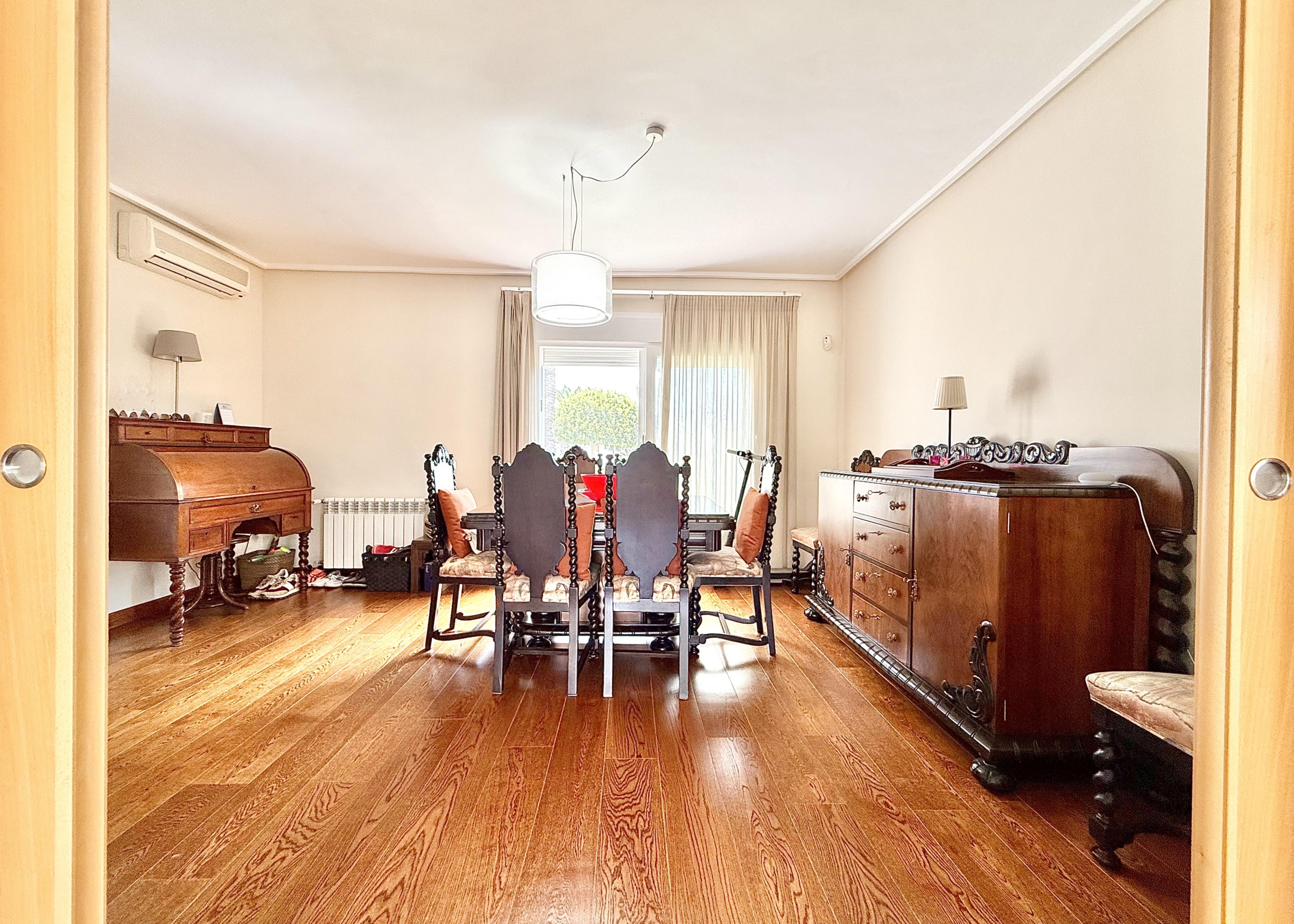 Spacious living and dining area with laminate flooring in a Levante Properties villa at Mar Menor Golf Resort.