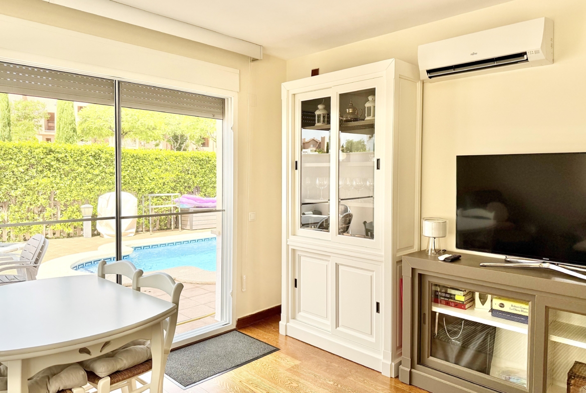 Spacious living and dining area with laminate flooring in a Levante Properties villa at Mar Menor Golf Resort.