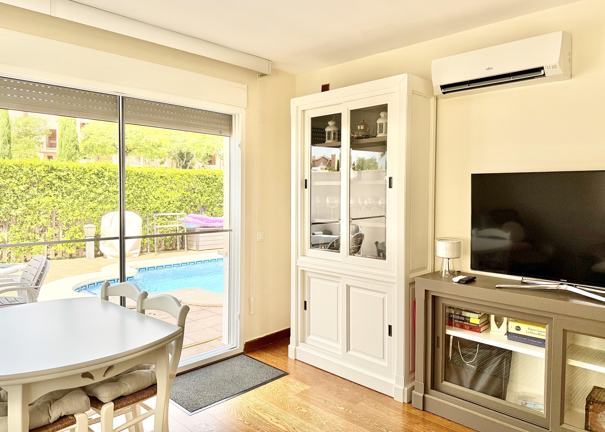Spacious living and dining area with laminate flooring in a Levante Properties villa at Mar Menor Golf Resort.