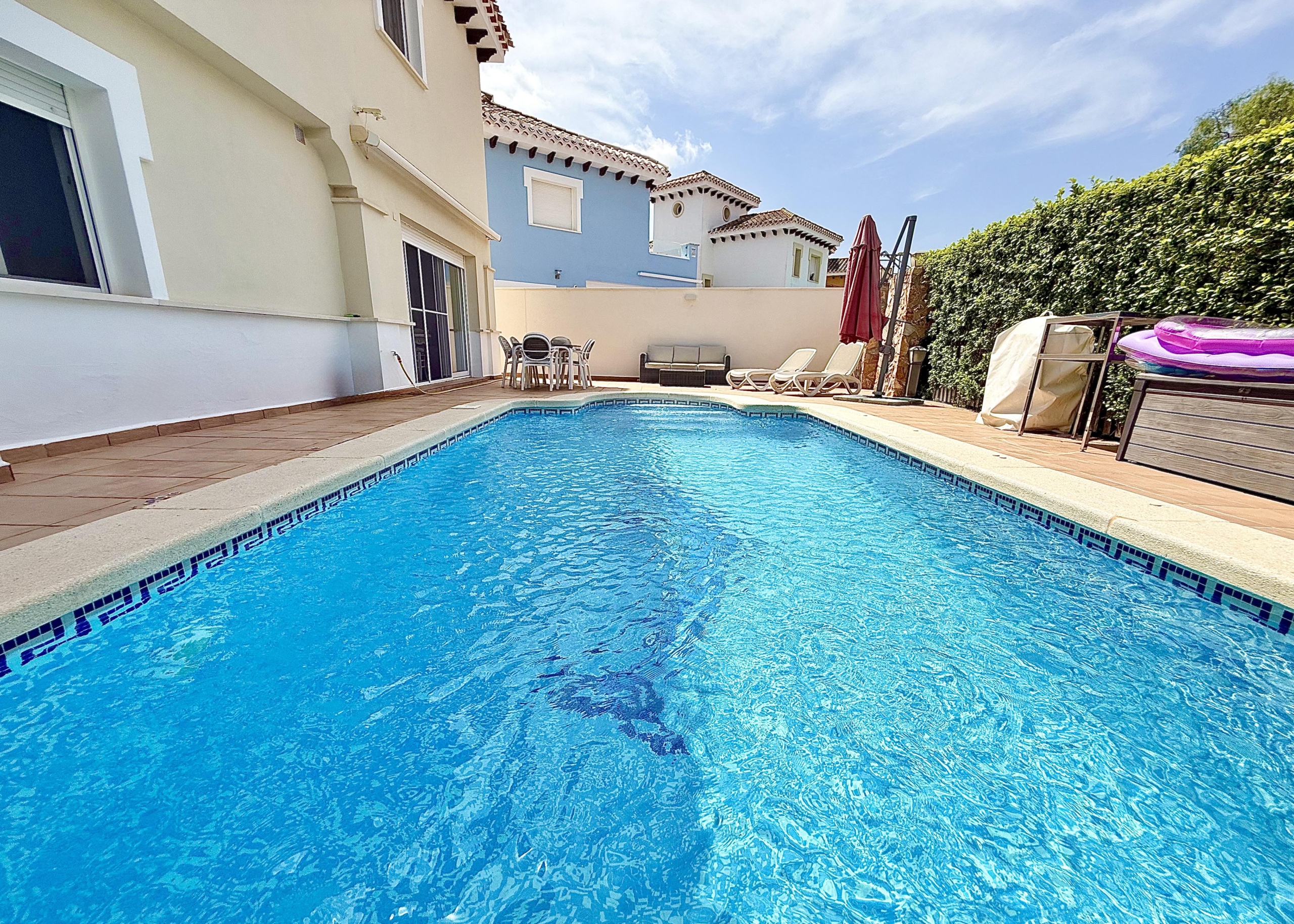 Private west-facing swimming pool and garden of a Baron villa at Mar Menor Golf Resort, listed by Levante Properties.