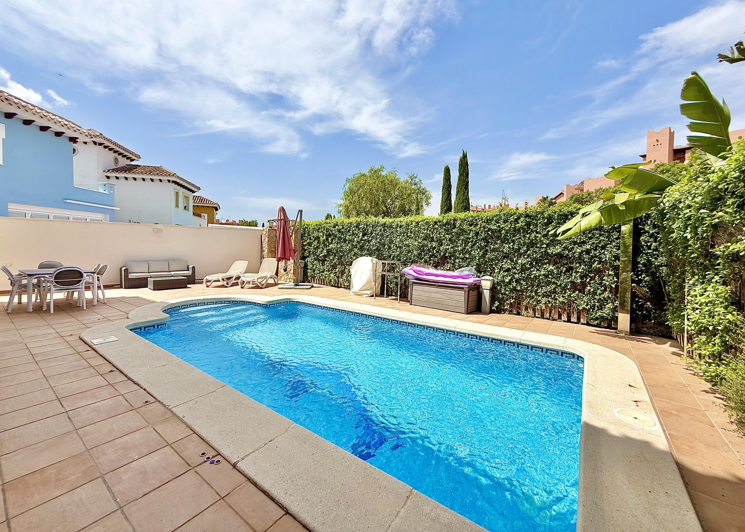 Private west-facing swimming pool and garden of a Baron villa at Mar Menor Golf Resort, listed by Levante Properties.