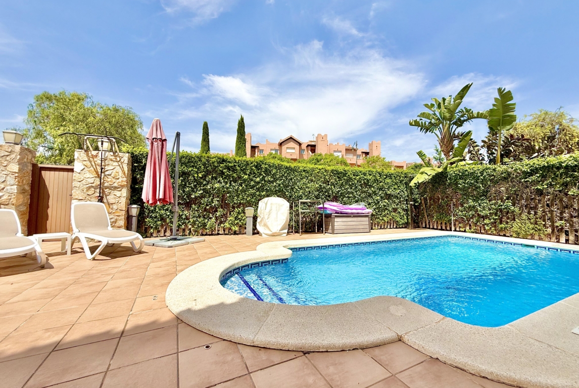 Private west-facing swimming pool and garden of a Baron villa at Mar Menor Golf Resort, listed by Levante Properties.