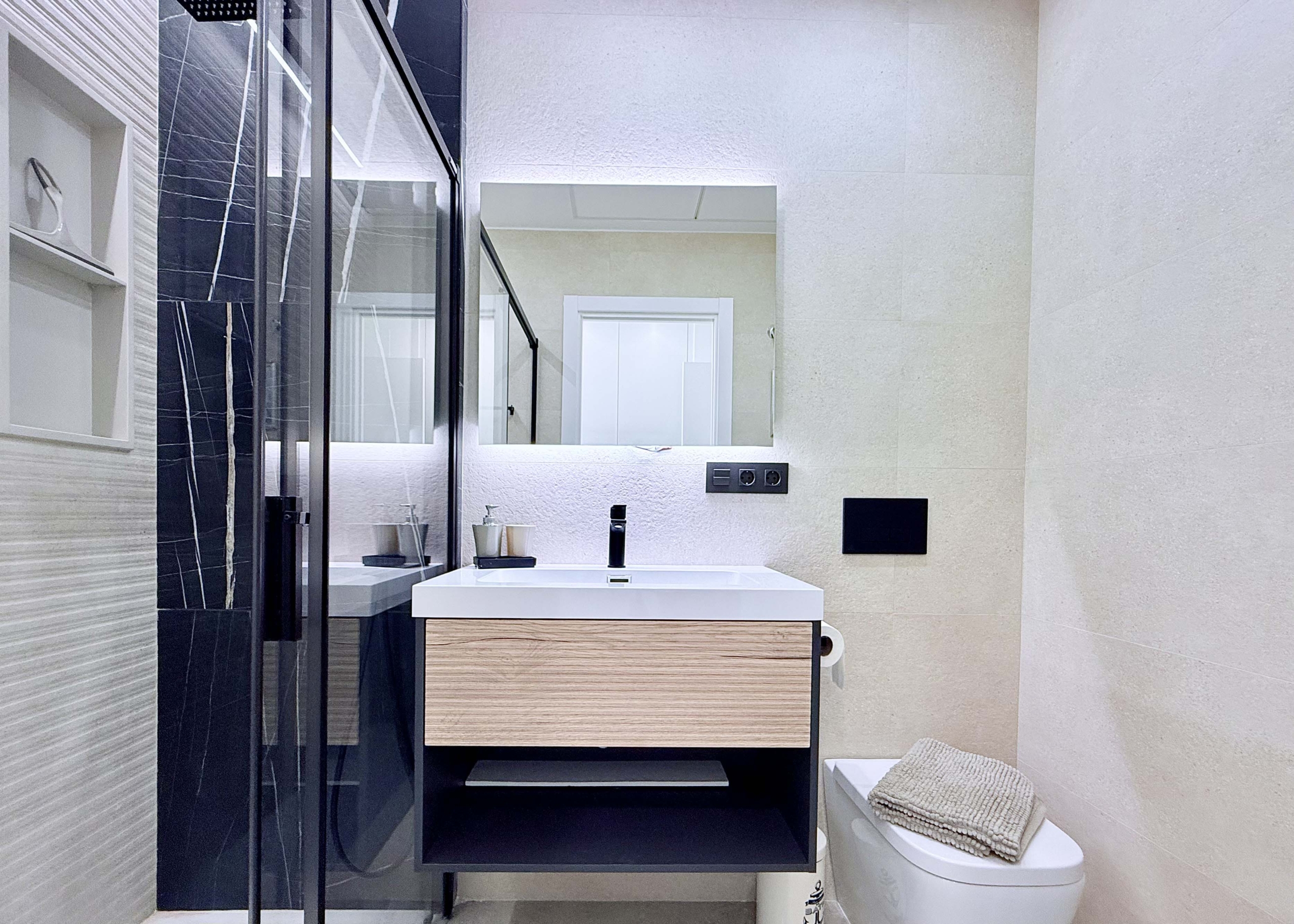 Contemporary bathroom in Mirador apartment with walk-in shower