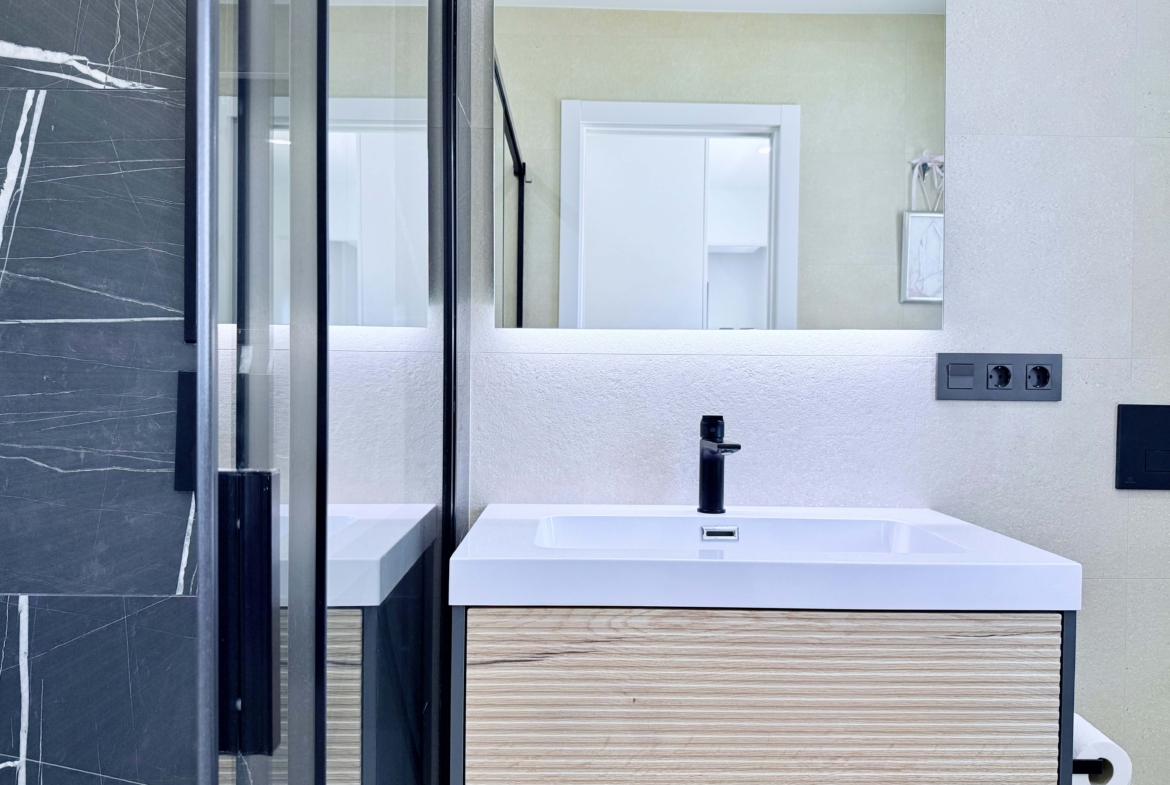 Contemporary bathroom in Mirador apartment with walk-in shower