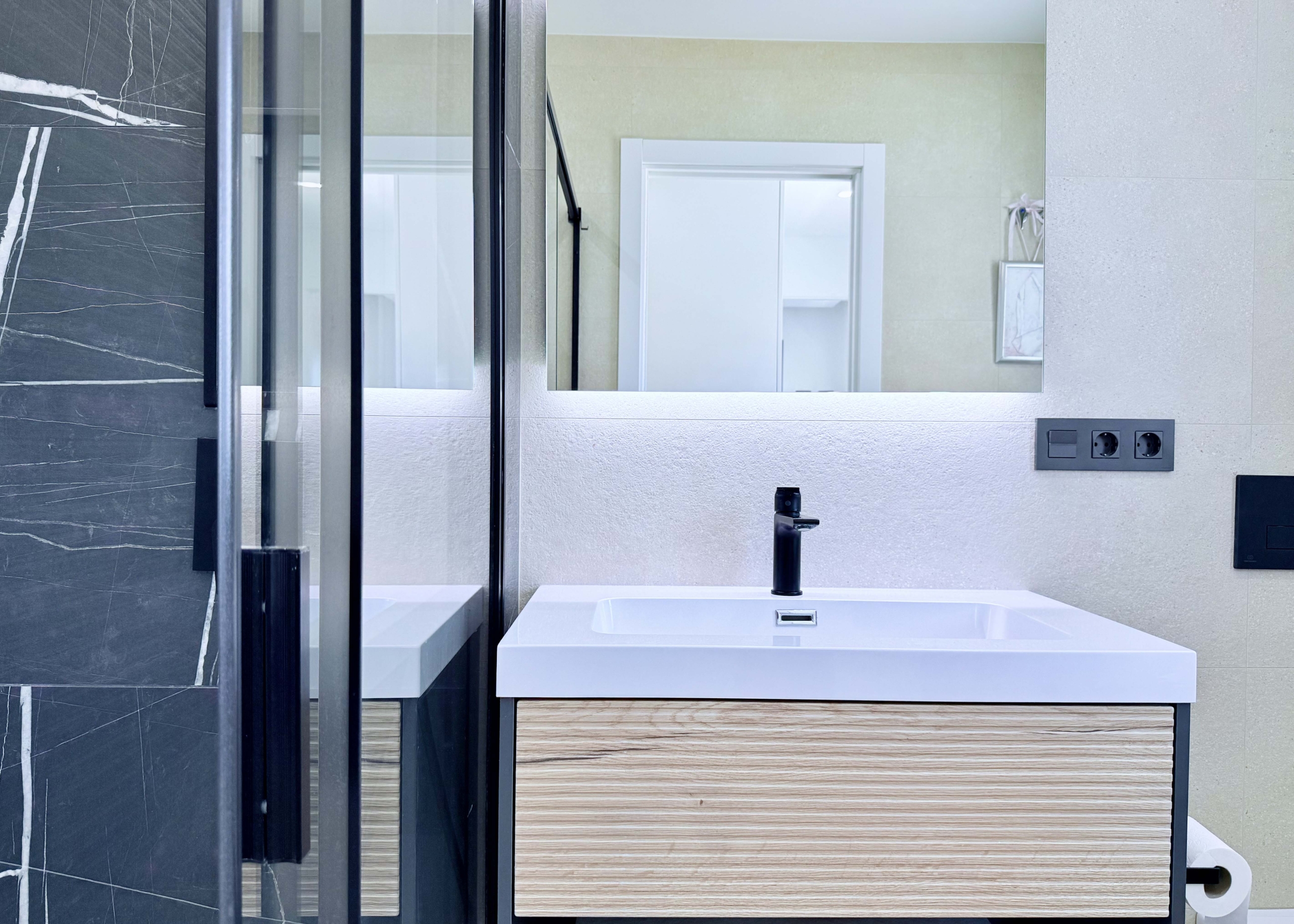 Contemporary bathroom in Mirador apartment with walk-in shower