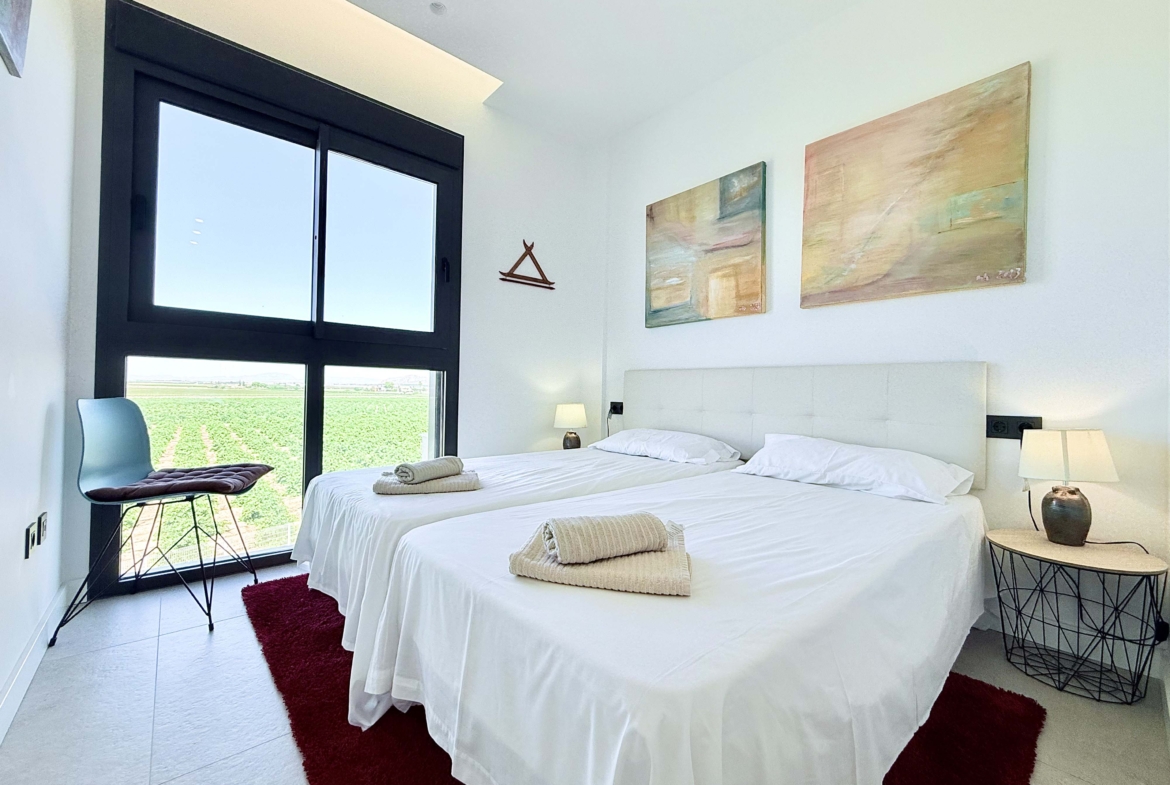 Bright second bedroom in Mirador apartment with modern décor