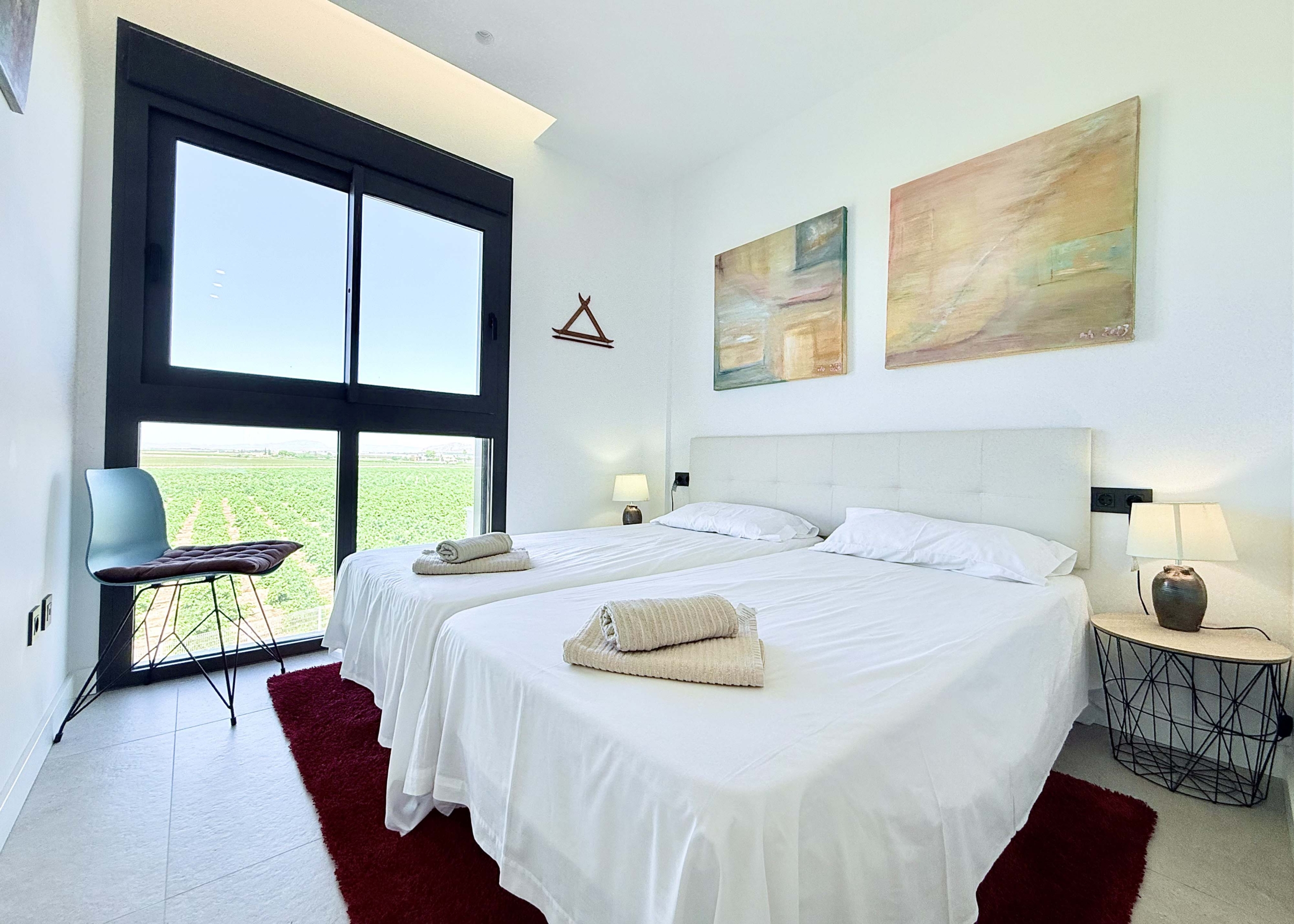 Bright second bedroom in Mirador apartment with modern décor