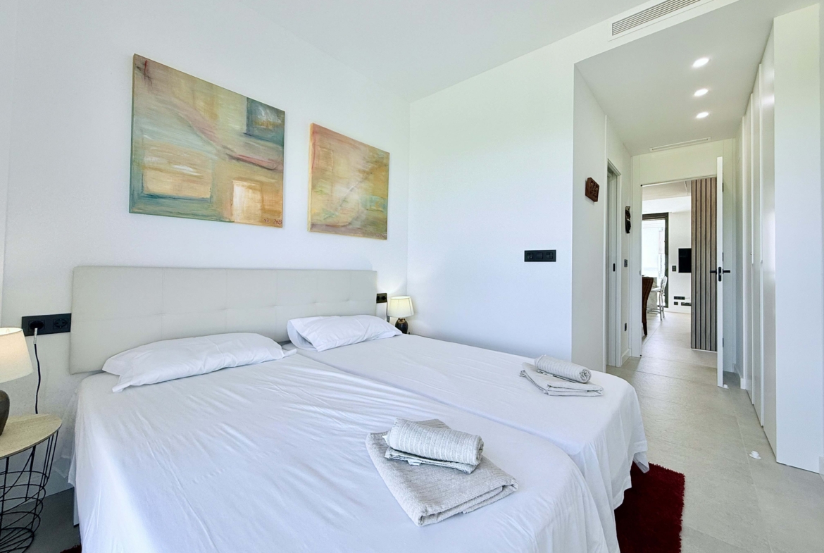 Bright second bedroom in Mirador apartment with modern décor