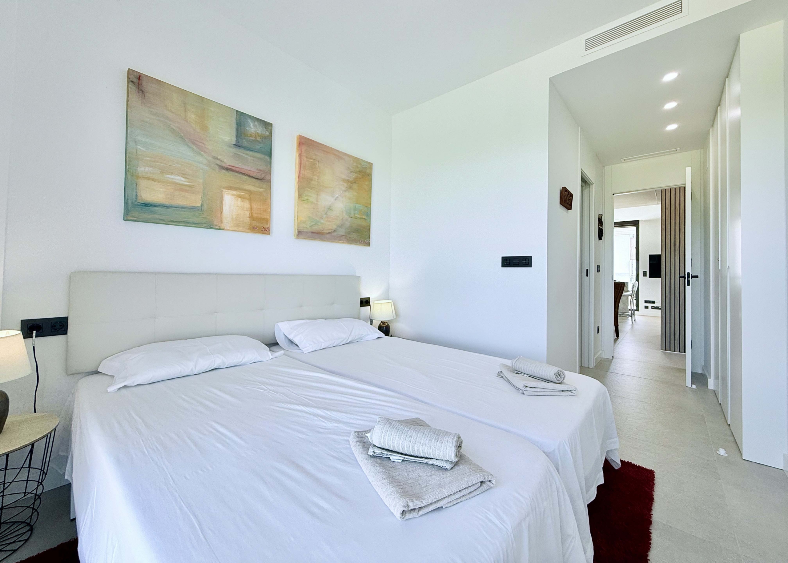 Bright second bedroom in Mirador apartment with modern décor