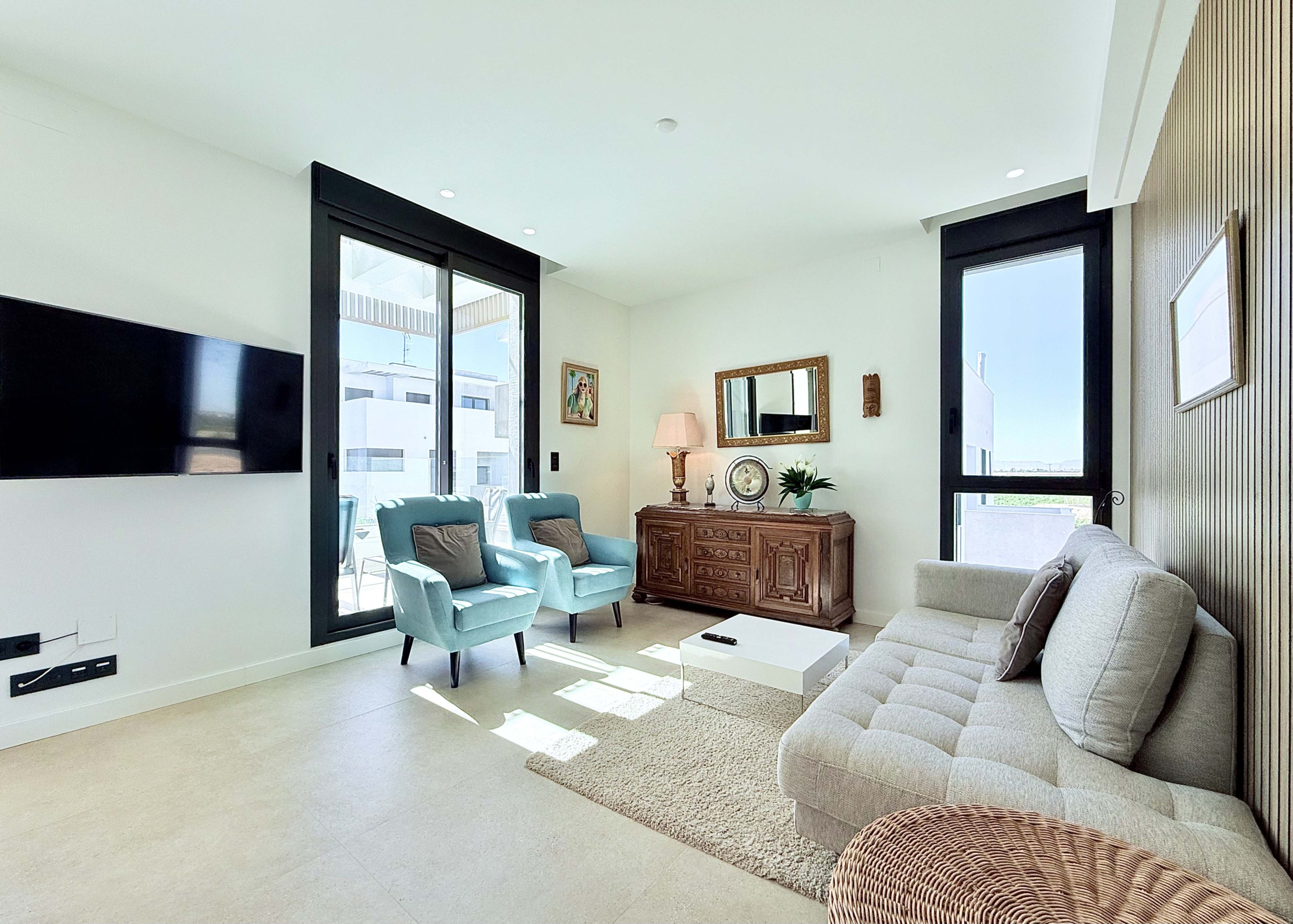 Open-plan living room inside Mirador apartment with terrace access