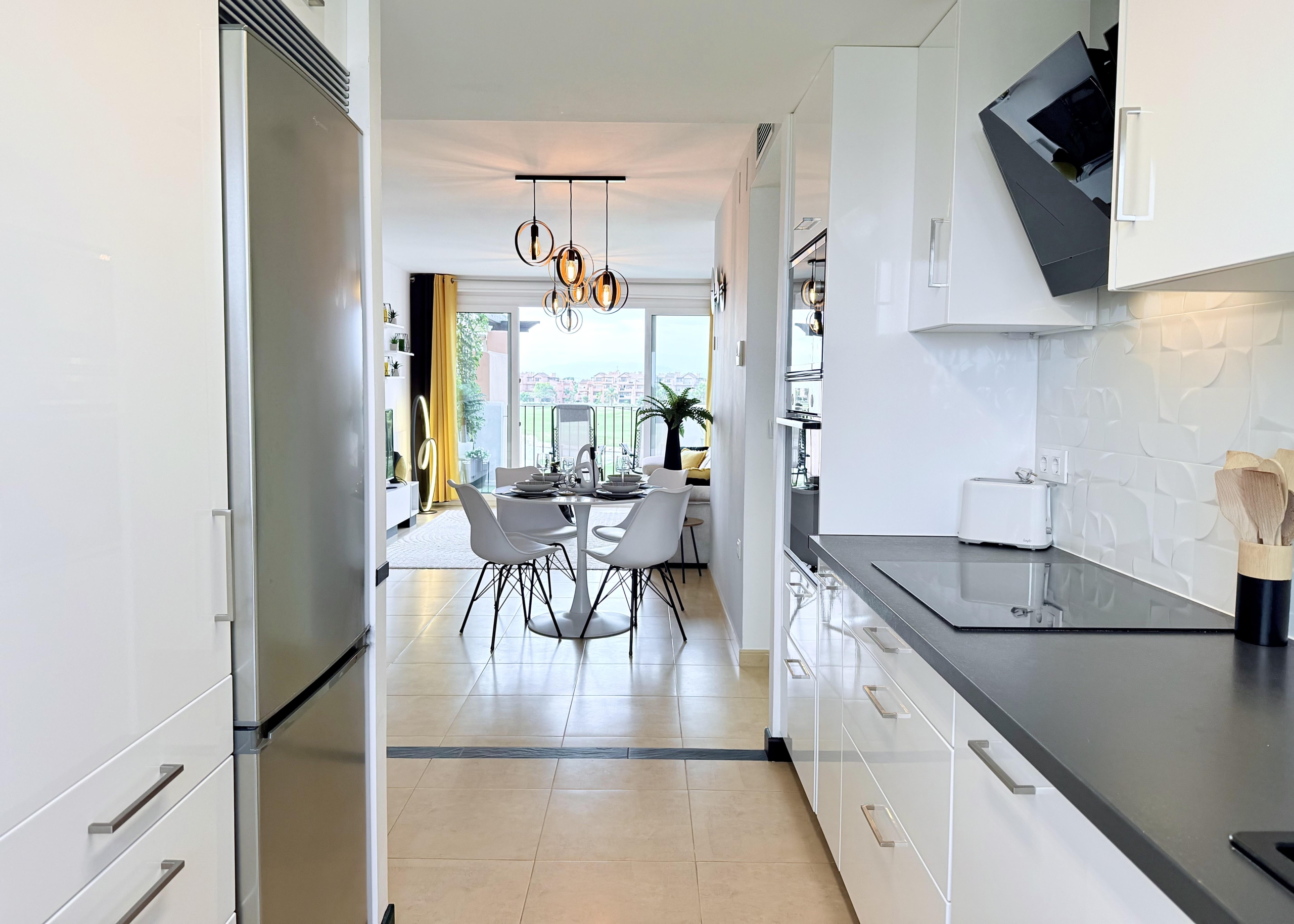 Modern open-plan kitchen in Mar Menor Golf Resort penthouse with Bosch appliances