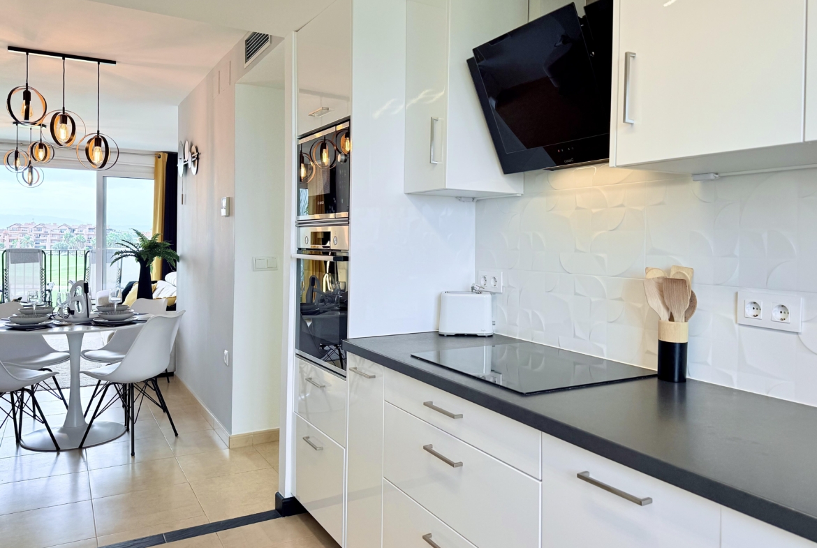 Modern open-plan kitchen in Mar Menor Golf Resort penthouse with Bosch appliances