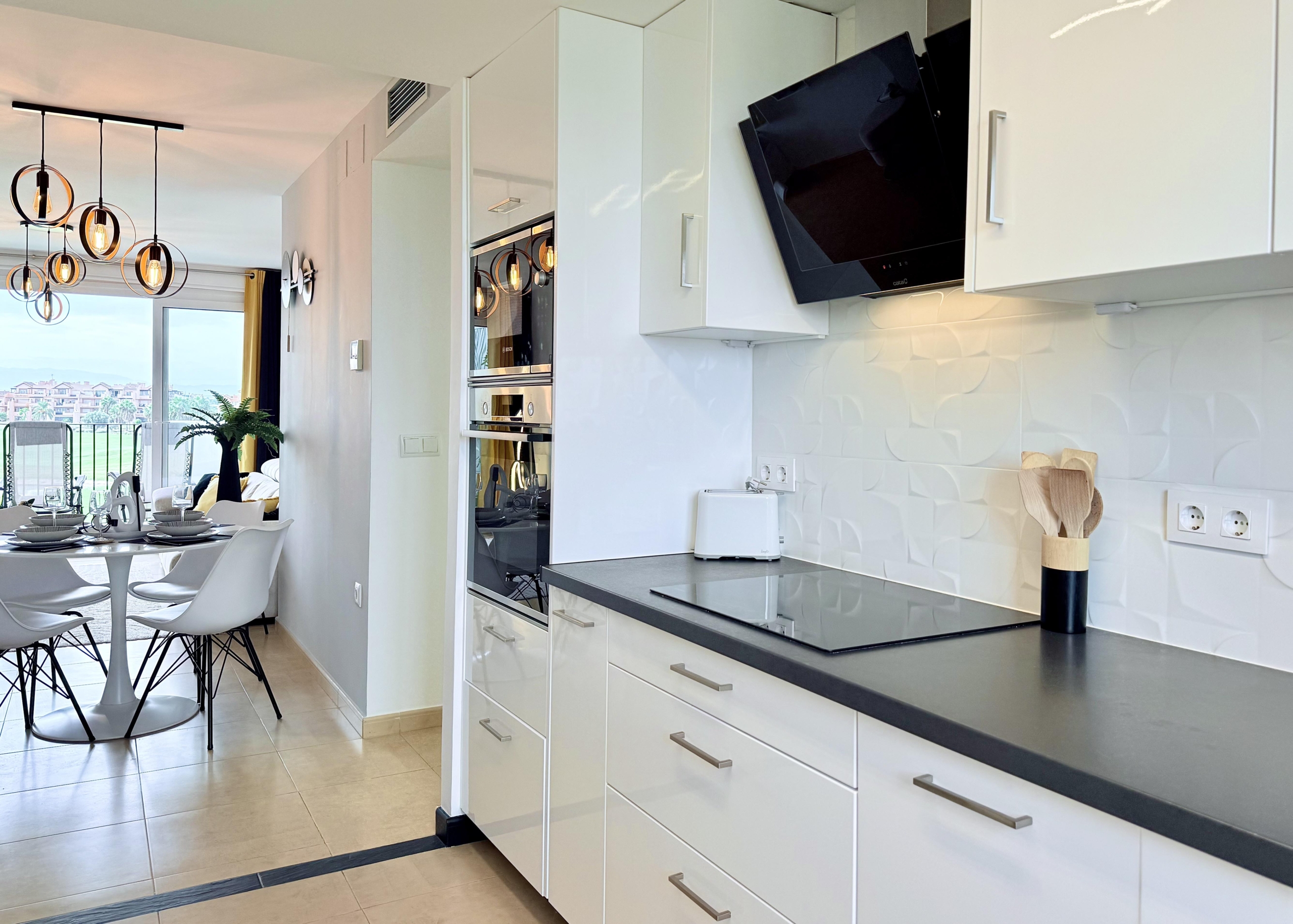 Modern open-plan kitchen in Mar Menor Golf Resort penthouse with Bosch appliances
