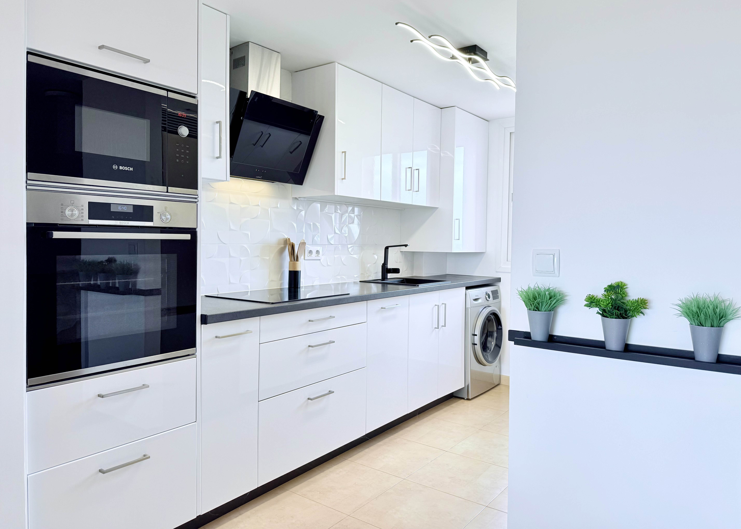 Modern open-plan kitchen in Mar Menor Golf Resort penthouse with Bosch appliances