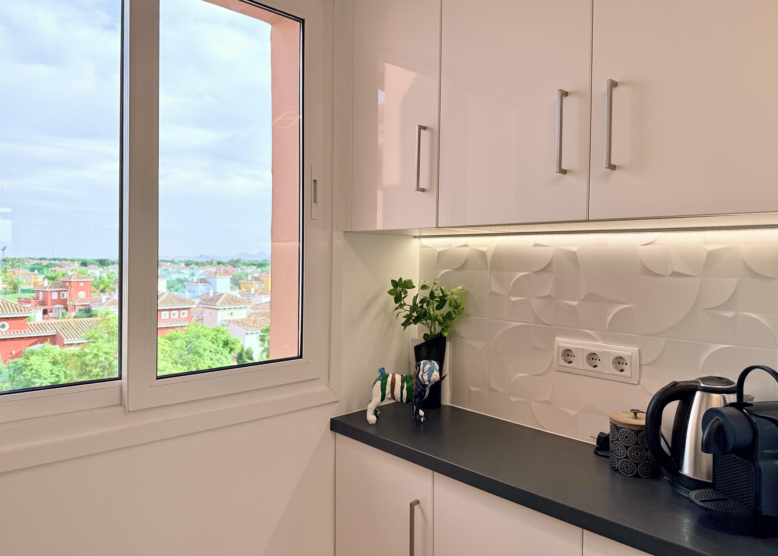 Modern open-plan kitchen in Mar Menor Golf Resort penthouse with Bosch appliances