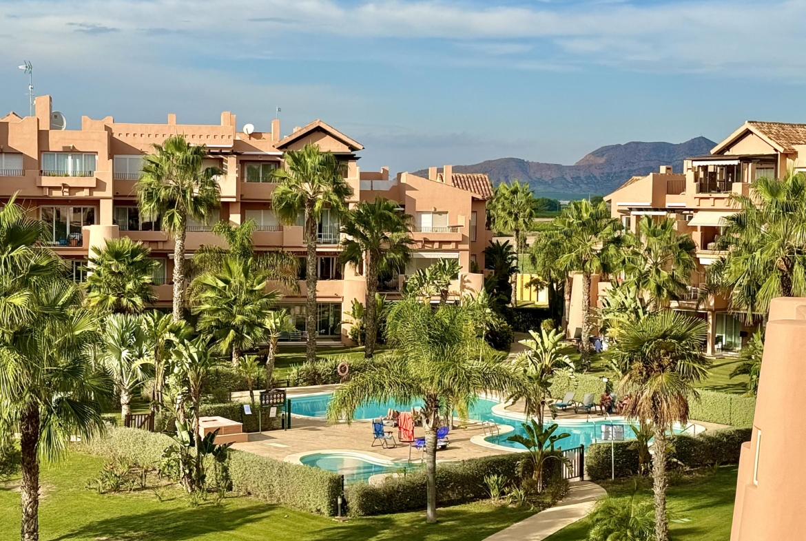 Outdoor swimming pool at Mar Menor Resort with sun loungers and palm trees