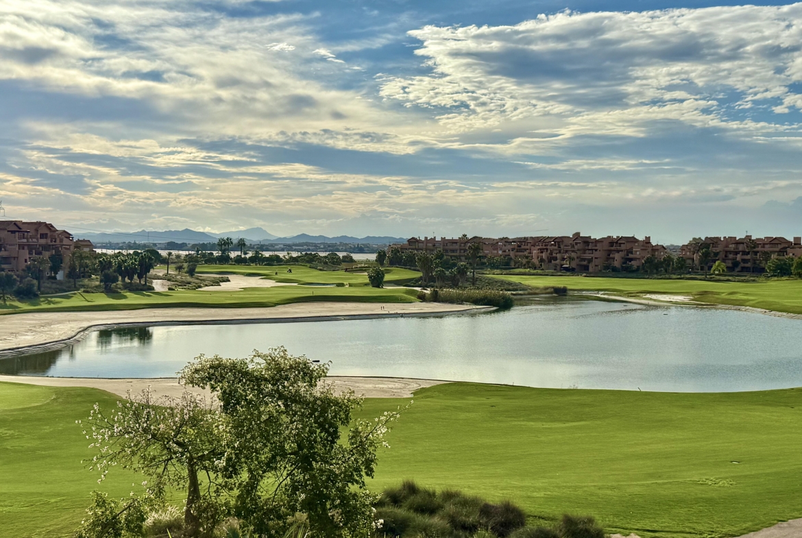 Mar Menor Resort lake with reflections of palm trees and landscaped greenery