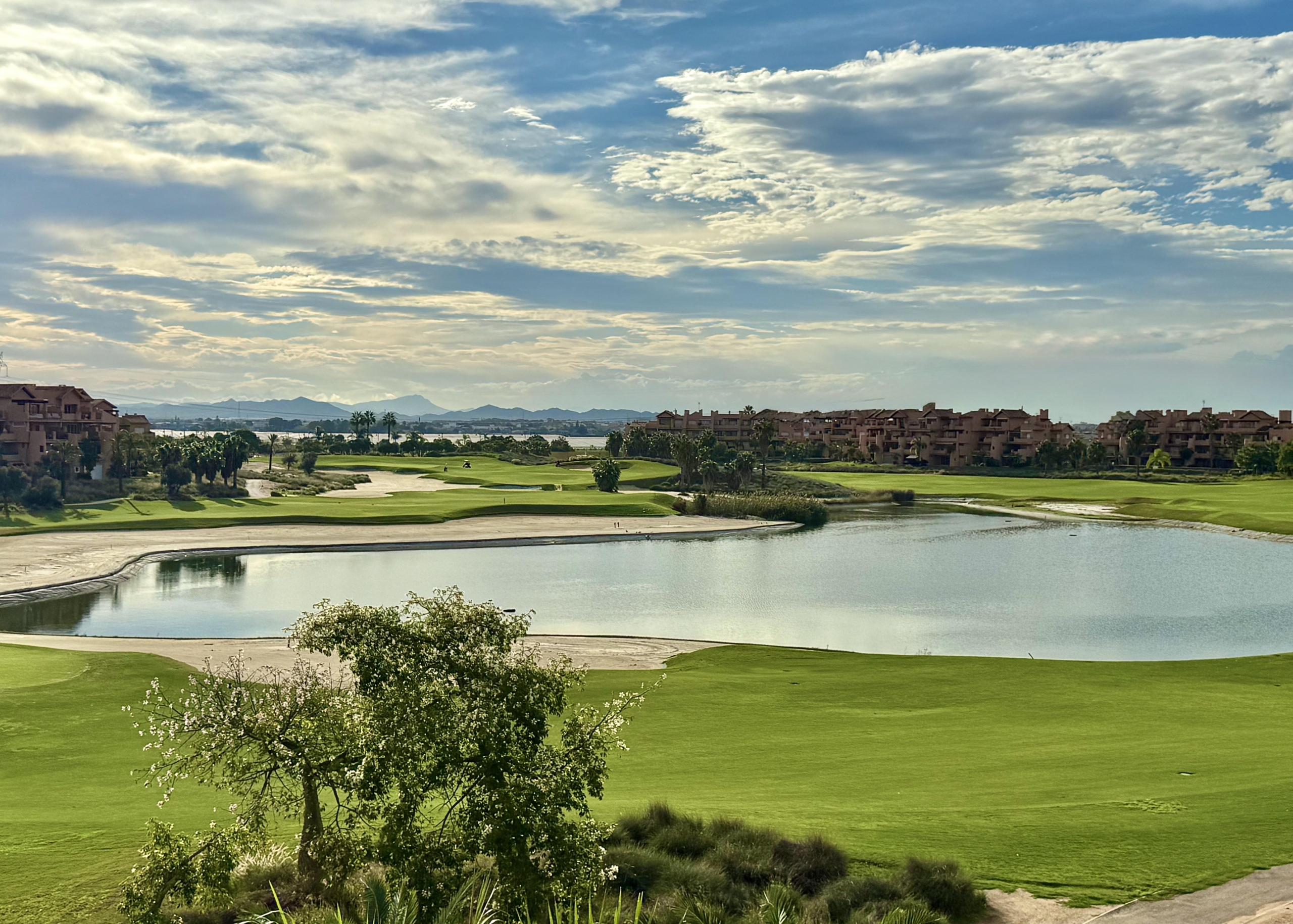 Mar Menor Resort lake with reflections of palm trees and landscaped greenery