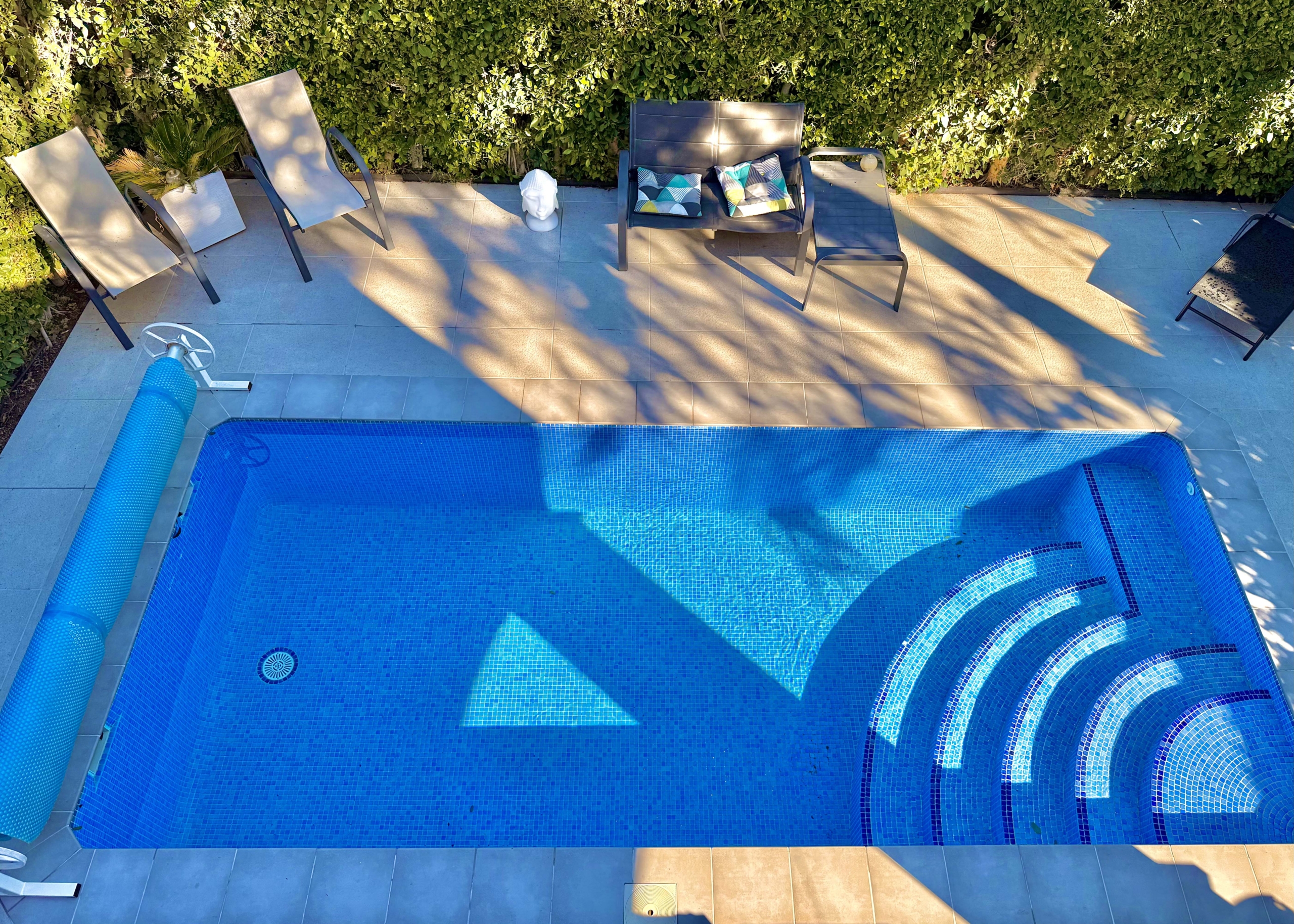 Heated private pool and modern tiled garden at the Isla Grosa villa on Mar Menor Golf Resort.