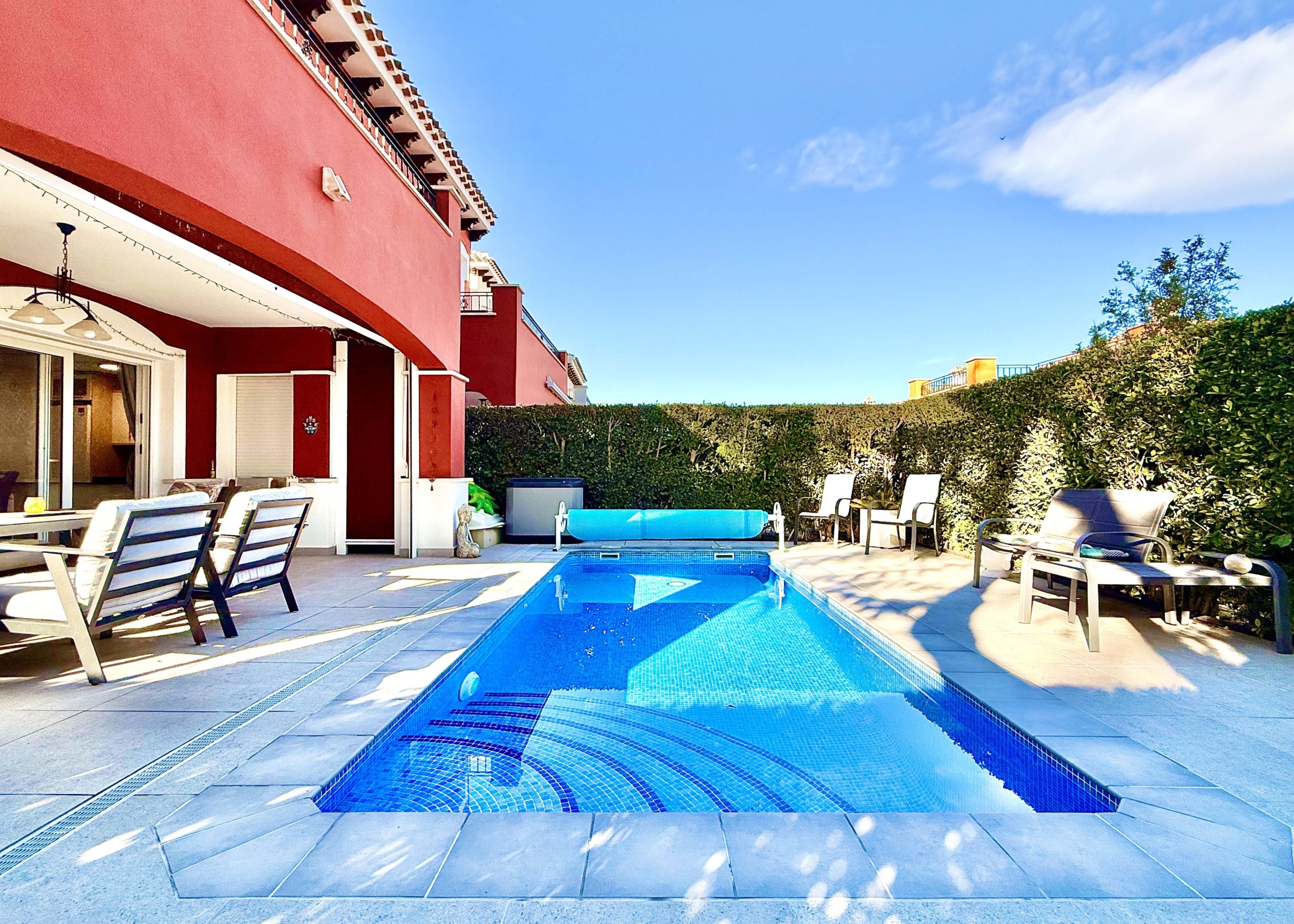 Heated private pool and modern tiled garden at the Isla Grosa villa on Mar Menor Golf Resort.