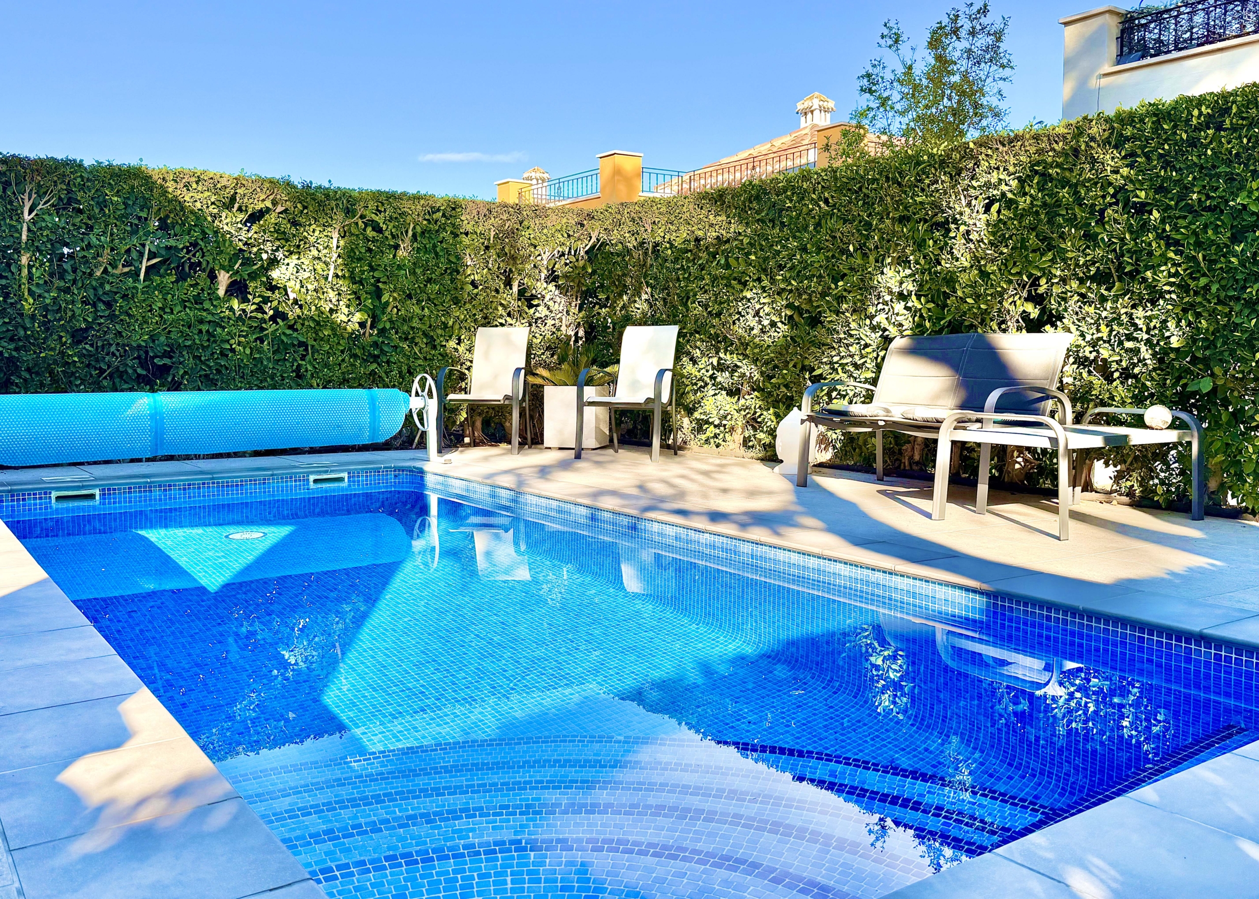 Heated private pool and modern tiled garden at the Isla Grosa villa on Mar Menor Golf Resort.