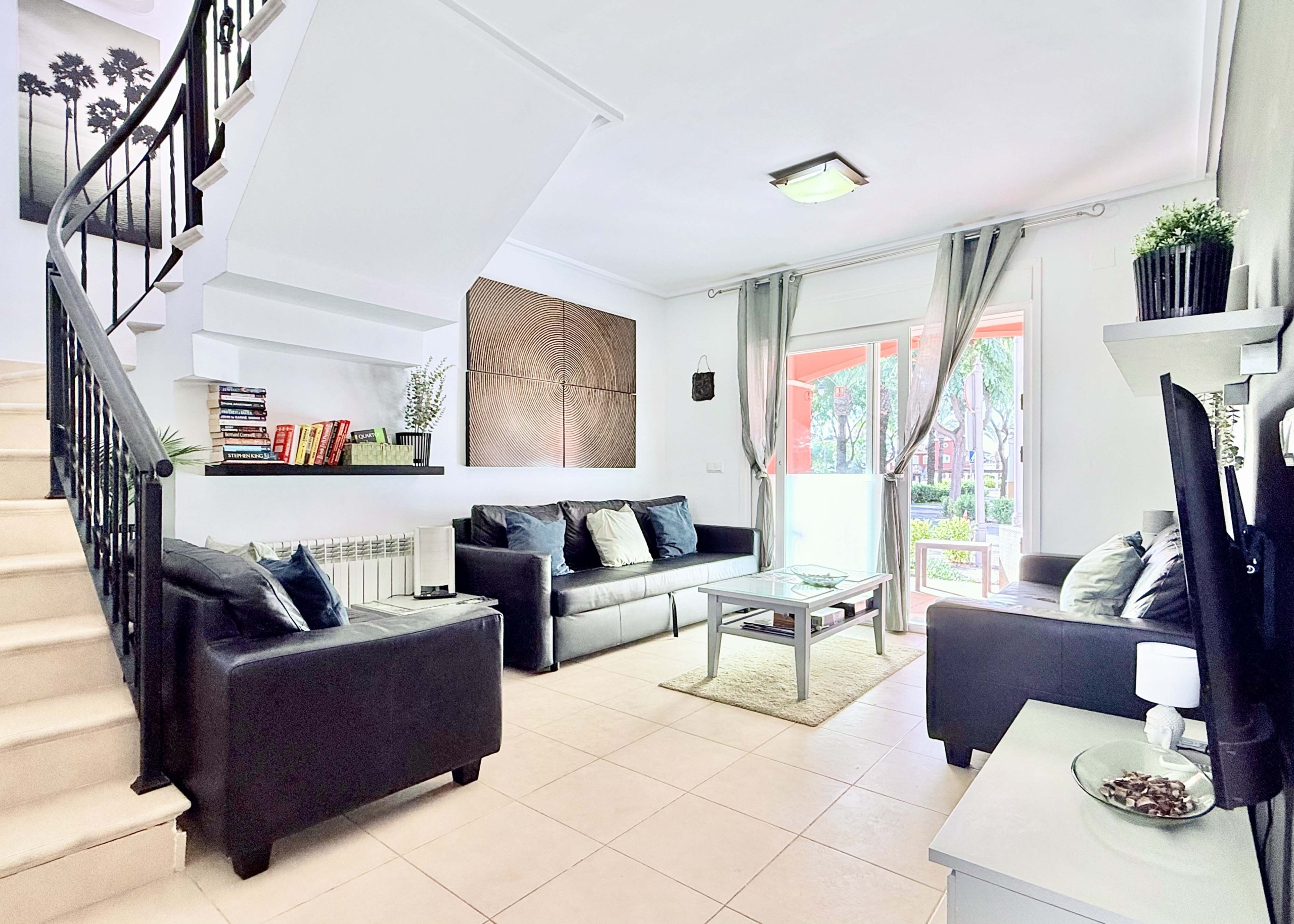 Open-plan living and dining area with terrace access at the Isla Grosa villa on Mar Menor Golf Resort.