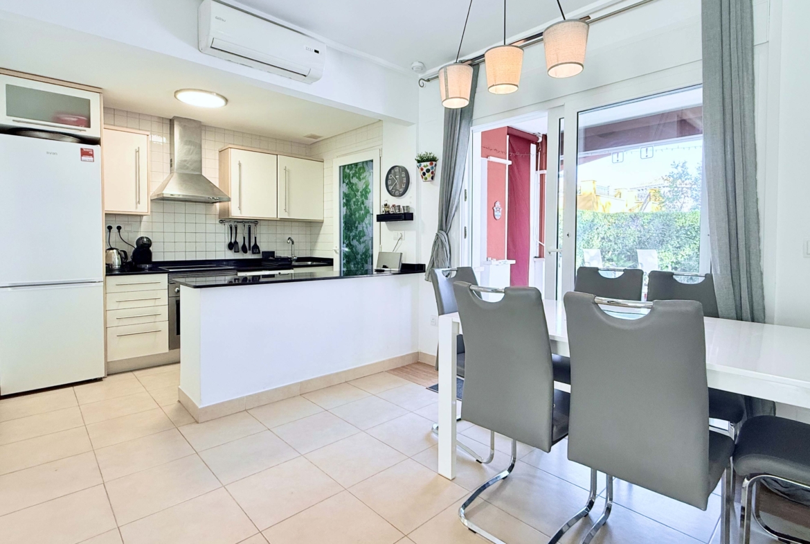 Open-plan living and dining area with terrace access at the Isla Grosa villa on Mar Menor Golf Resort.
