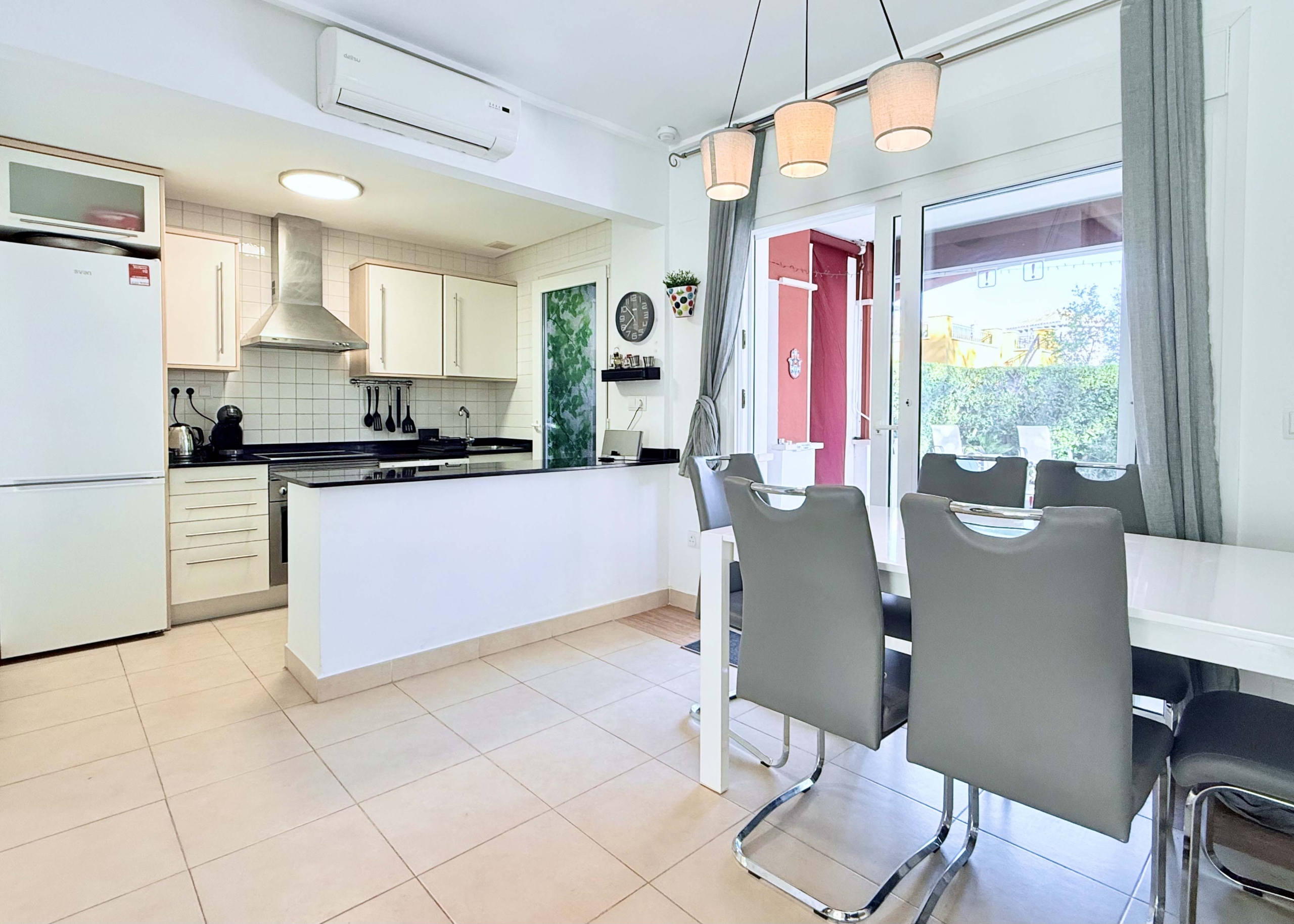 Open-plan living and dining area with terrace access at the Isla Grosa villa on Mar Menor Golf Resort.