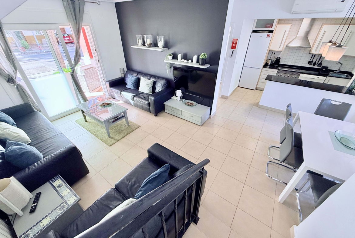 Open-plan living and dining area with terrace access at the Isla Grosa villa on Mar Menor Golf Resort.